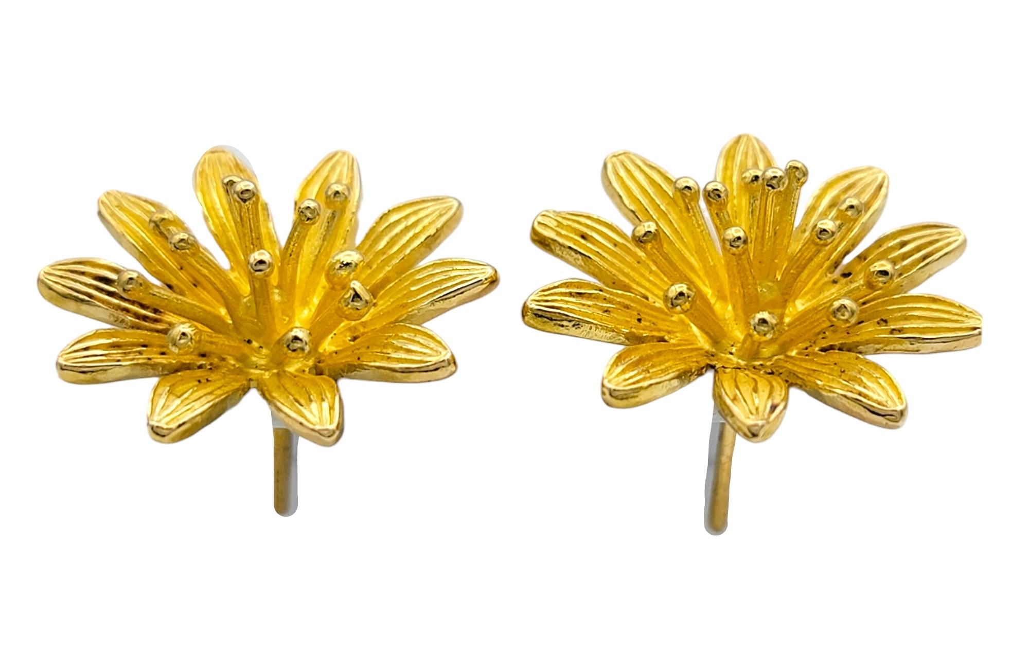 Discover the timeless allure of nature inspired elegance with these captivating three dimensional flower stud earrings, meticulously crafted in brushed 14 karat yellow gold. These earrings bring a delicate bloom to life, with each petal gracefully