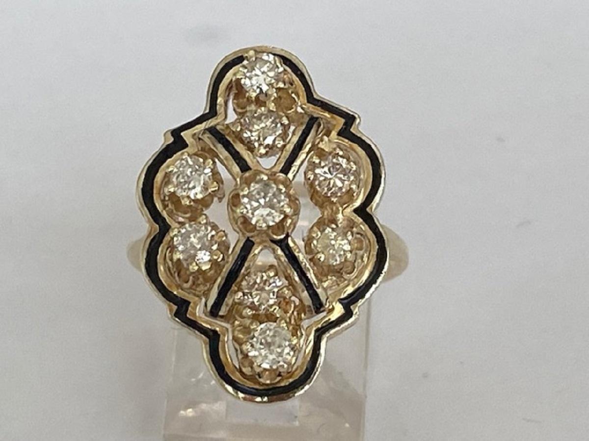 In good condition, a 14 kt yellow gold cocktail ring with 9 brilliant cut diamonds, with an estimated weight of approx. 0.70 carat in total, quality H/ SI2/P.
The head of the ring is decorated with black enamel. 
Grade: 585 (tested)
Natural diamonds