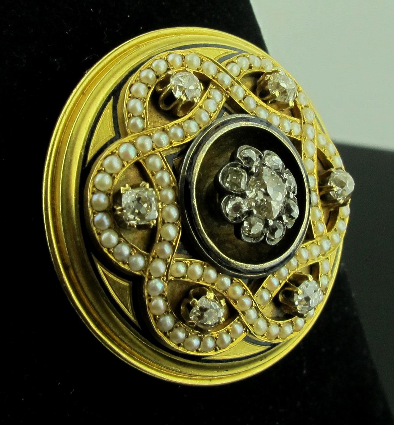 This vintage brooch is set in 14 karat yellow gold and includes 15 Old Mine cut diamonds with a total diamond weight of 1.50 carats. Pearls are in a woven pattern around 6 diamonds.  Gold weight is 23 grams.