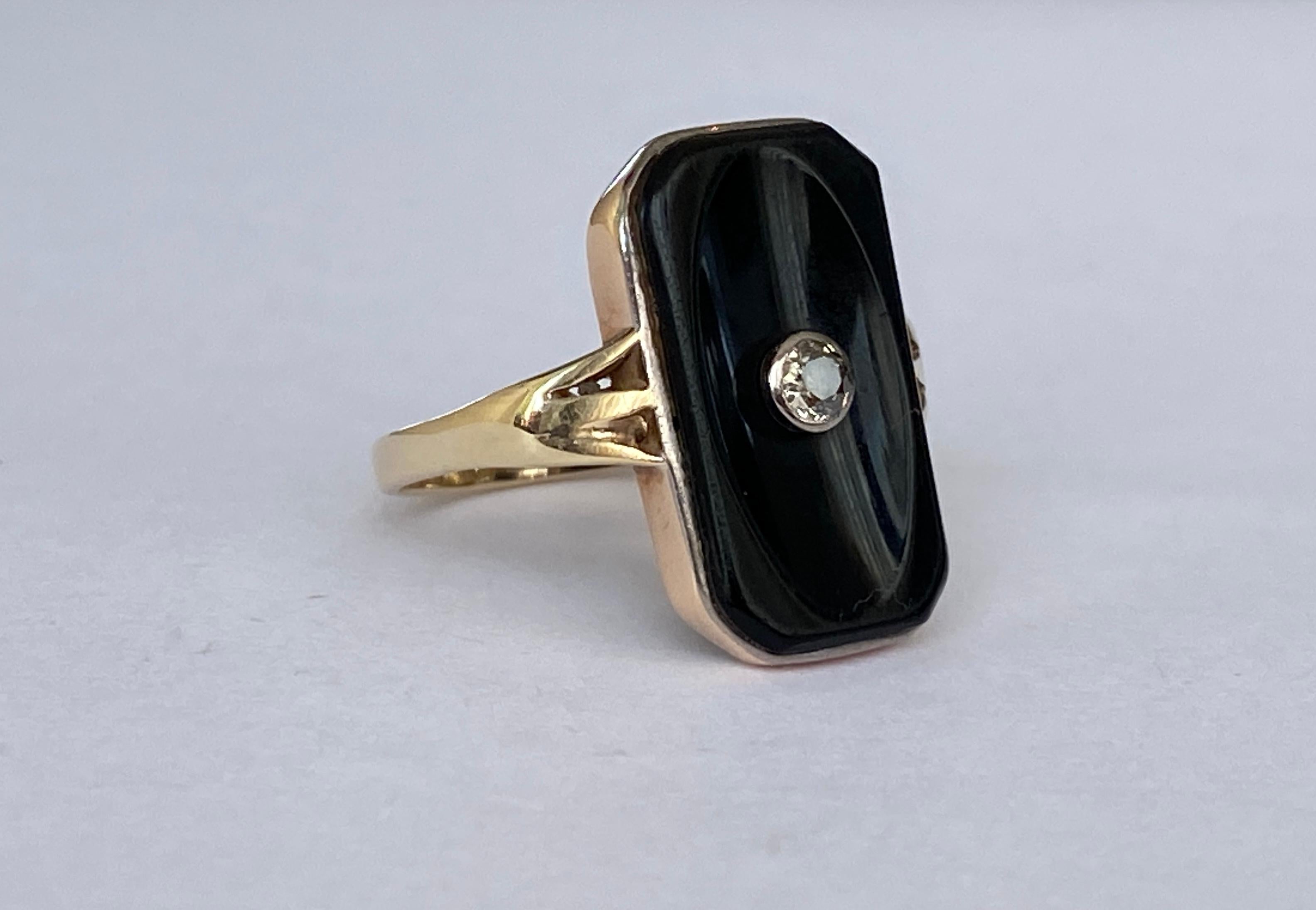 This stunning ring features an rose cut  diamond and a kite shaped black onyx stone, creating a unique and elegant design. The diamond's antique cut adds extra sparkle and the black onyx provides a bold contrast. Perfect for adding a touch of
