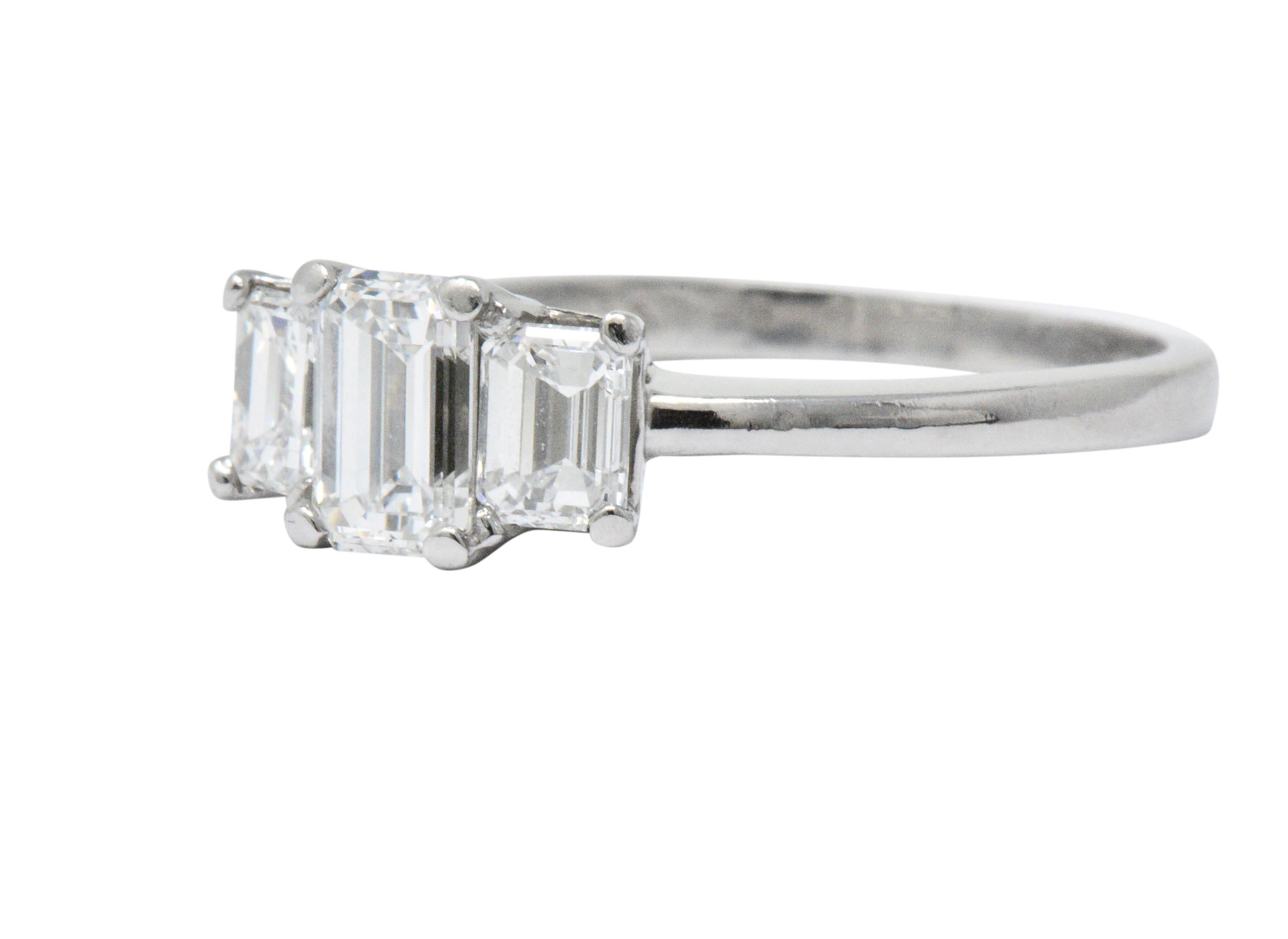 Designed as a three stone basket style ring centering an emerald cut diamond weighing approximately 0.70 carat, G color with VS clarity

Flanked by two more emerald cut diamonds weighing in total approximately 0.70 carat, F/G color with VS
