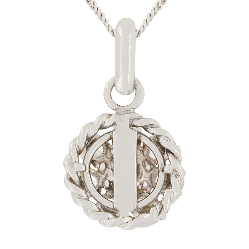 A cluster of eight round brilliant diamonds form this vintage pendant. Each stone is individually claw set into an 18ct white gold setting. In the centre sits the largest of the eight diamonds, weighing 0.35 carat. The surrounding seven diamonds