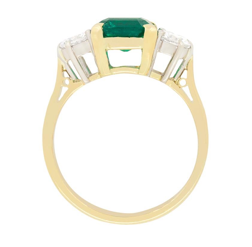 Made in the 1950s is this gorgeous Emerald and diamond trilogy ring. To the centre a 1.40 carat, square cut emerald is set, flanked by a pair of round brilliant diamonds. Each glistening diamond weighs 0.30 carat and matches in quality at I in