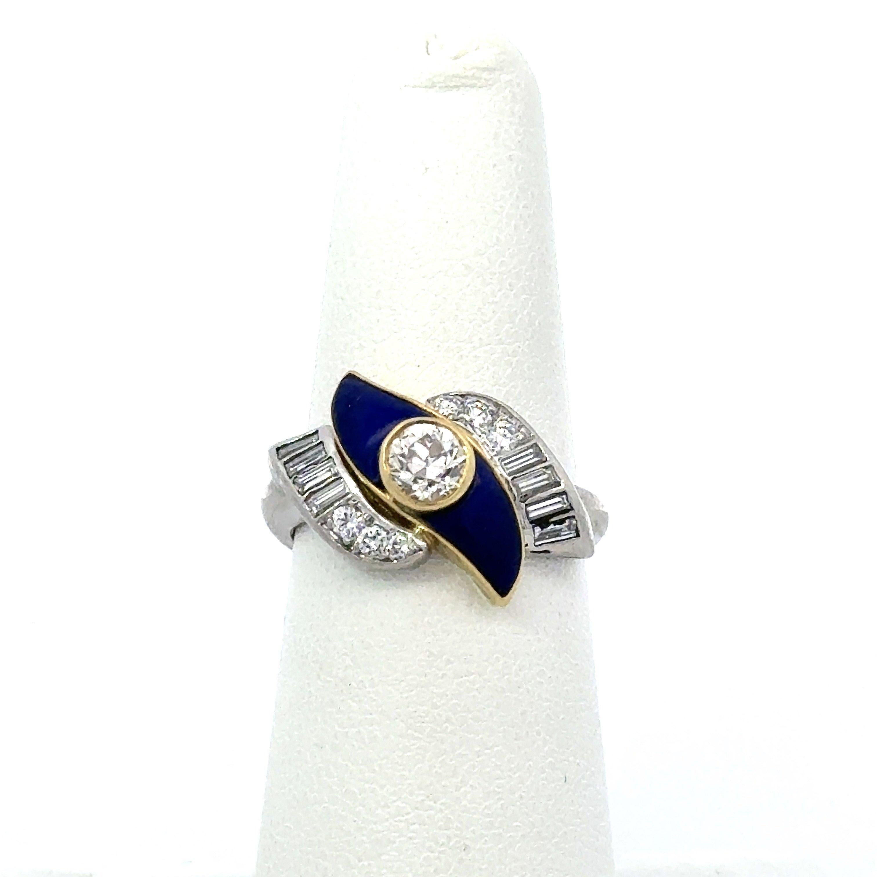 This vintage ring dates from the 1950's and it’s crafted in Platinum and 18KT Yellow Gold. It contains one .50CT Old European Cut bezel-set center Diamond K color  VS clarity and .93CT of Brilliant Round & Baguette Diamonds F-G Color VS-SI Clarity,