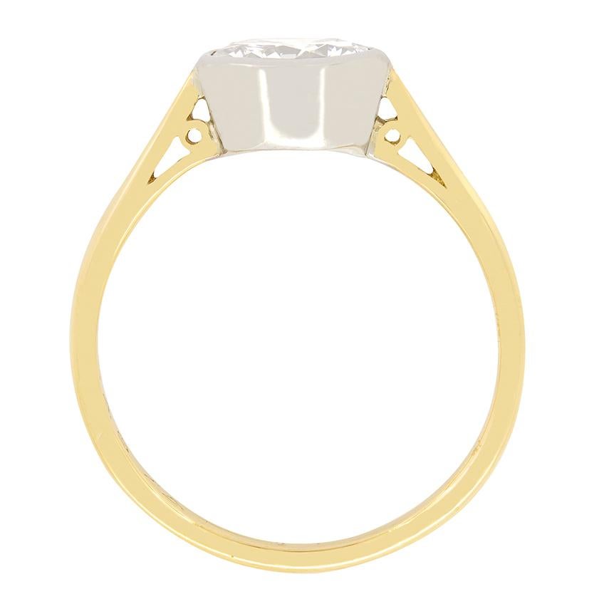 Crafted in the 1950s this solitaire ring features an impressive 1.45 carat diamond at its centre. The round brilliant cut stone has a colour of H and a clarity of VS1. It is rub over set into a solid platinum collet, giving this timeless solitaire a