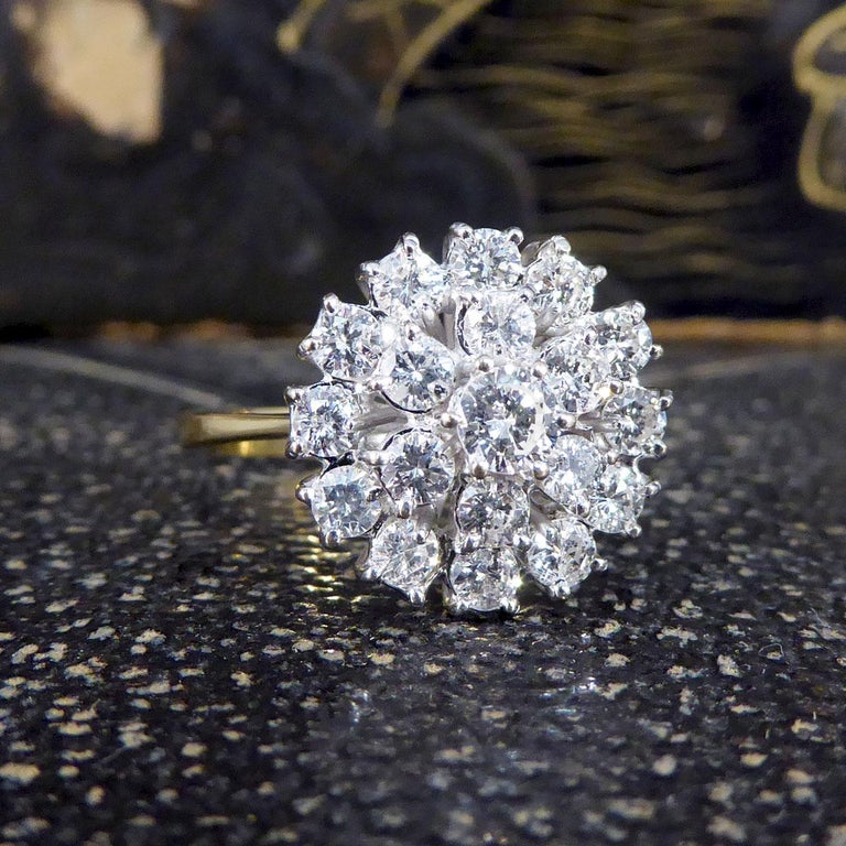 Such a lovely vintage ring modelled in 18ct Yellow Gold with an 18ct White Gold setting Flower Diamond cluster. This ring is holding a 20pt Diamonds in the centre with 7pt Diamonds clustering the centre to create a flower aesthetic. This ring holds