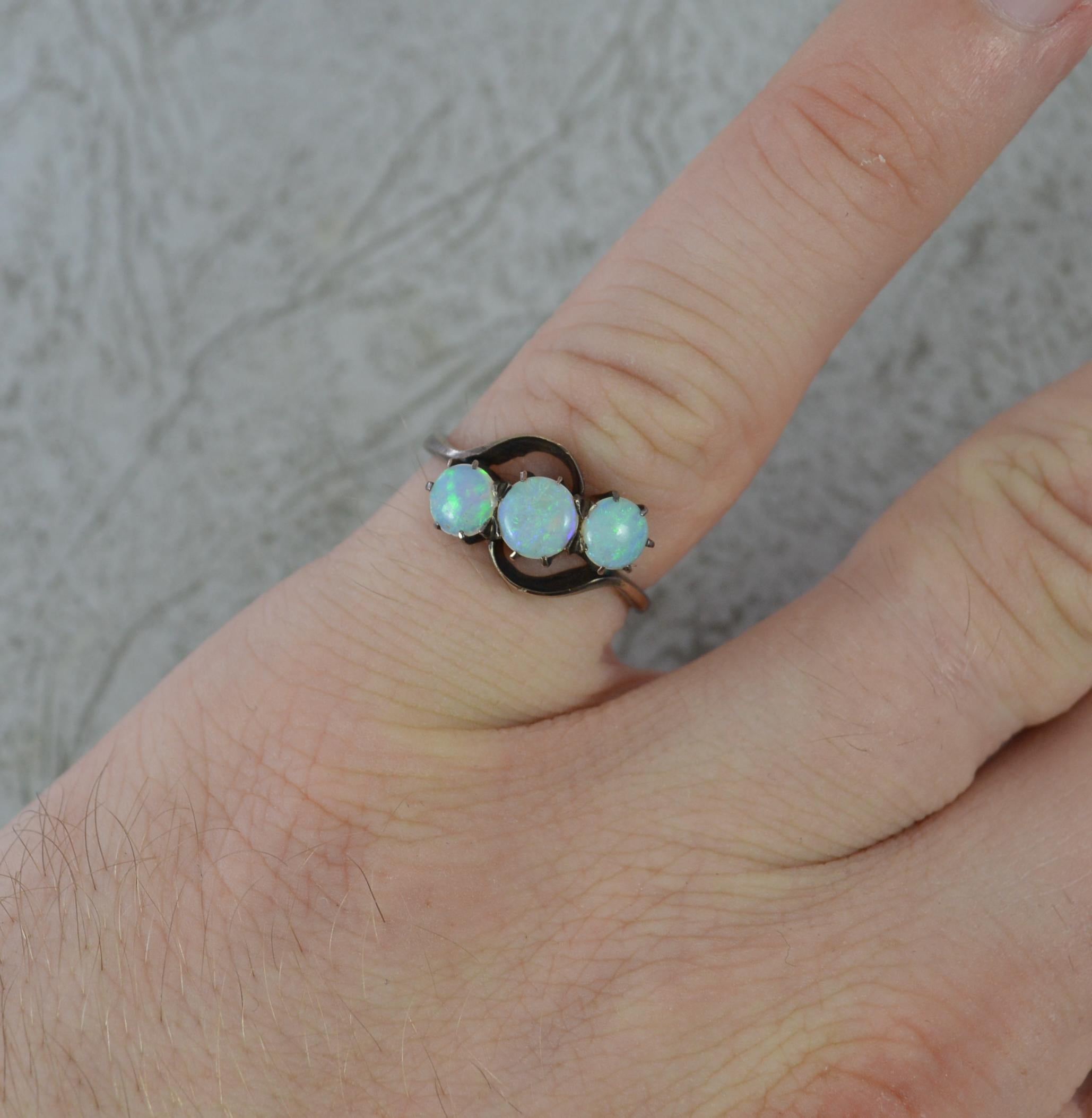 A superb natural opal ring.
Solid 14 carat gold example.
Designed with three round shaped natural opals in claw settings on twist.
13mm spread of stones.
Circa 1940/50.

CONDITION ; Very good. Well set stone. Crisp design. Light wear only. Please