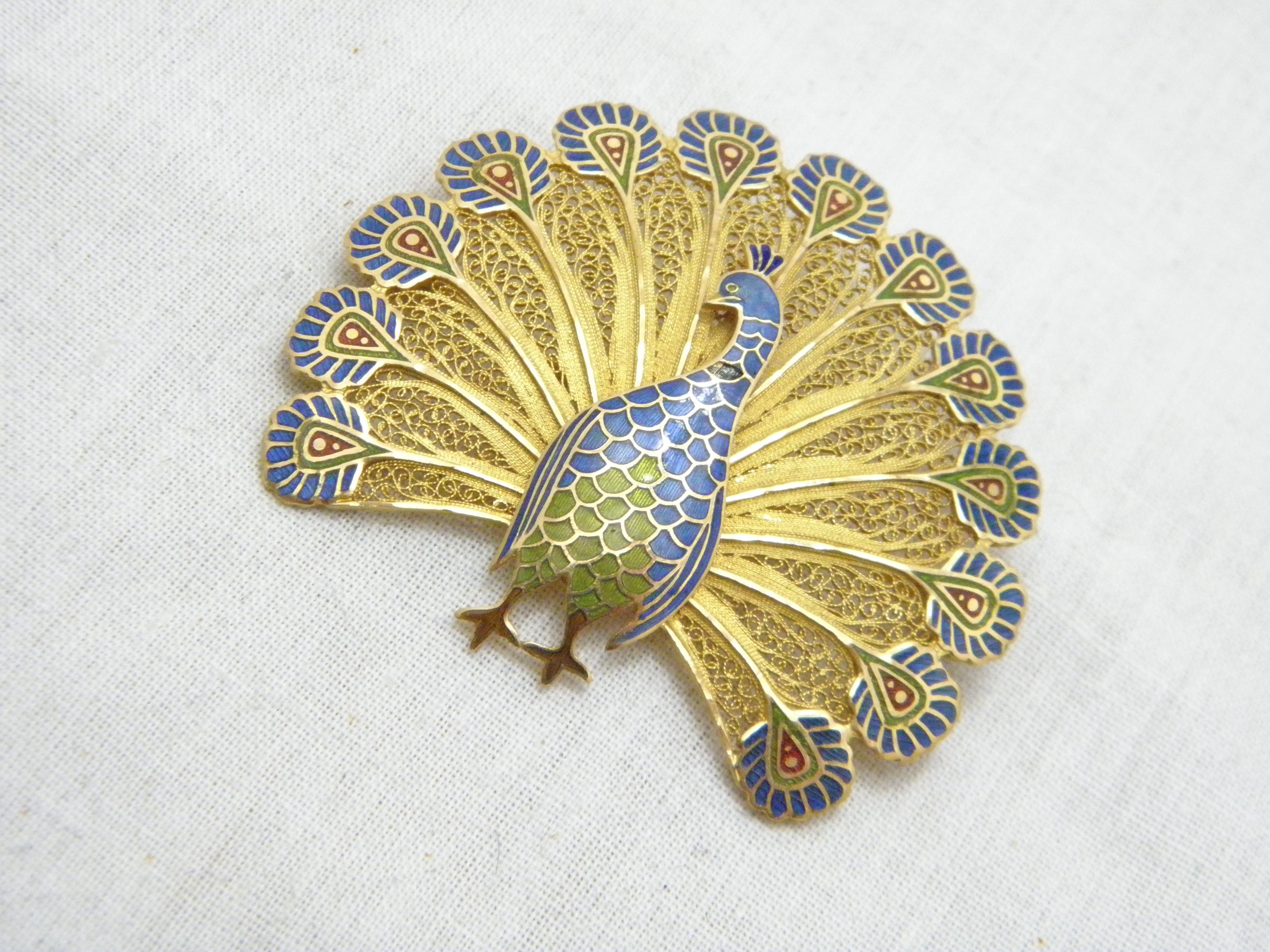 If you have landed on this page then you have an eye for beauty.

On offer is this gorgeous

14CT HEAVY SOLID GOLD PORTUGESE ENAMEL PEACOCK BROOCH

DETAILS
Material: 14ct (585/000) Solid Heavy Yellow Gold
Style: Bespoke designer highly detailed