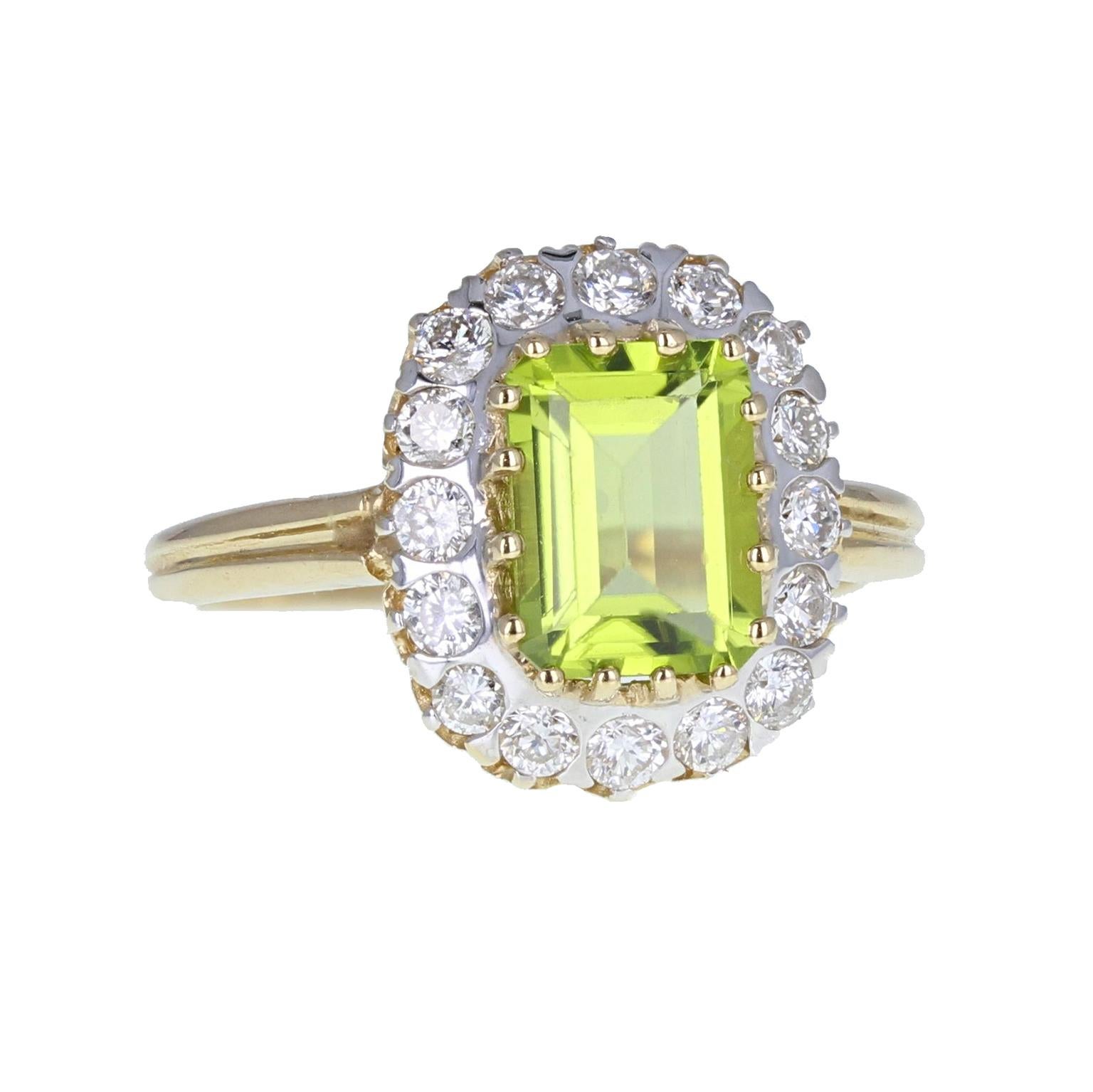 A stylish and unusual vintage cocktail ring featuring a fabulous lime-green coloured emerald-cut peridot mounted in 14-carat yellow gold claws. Surrounded by 16 round brilliant-cut diamonds to form a rectangular cluster. The simple slightly tapering