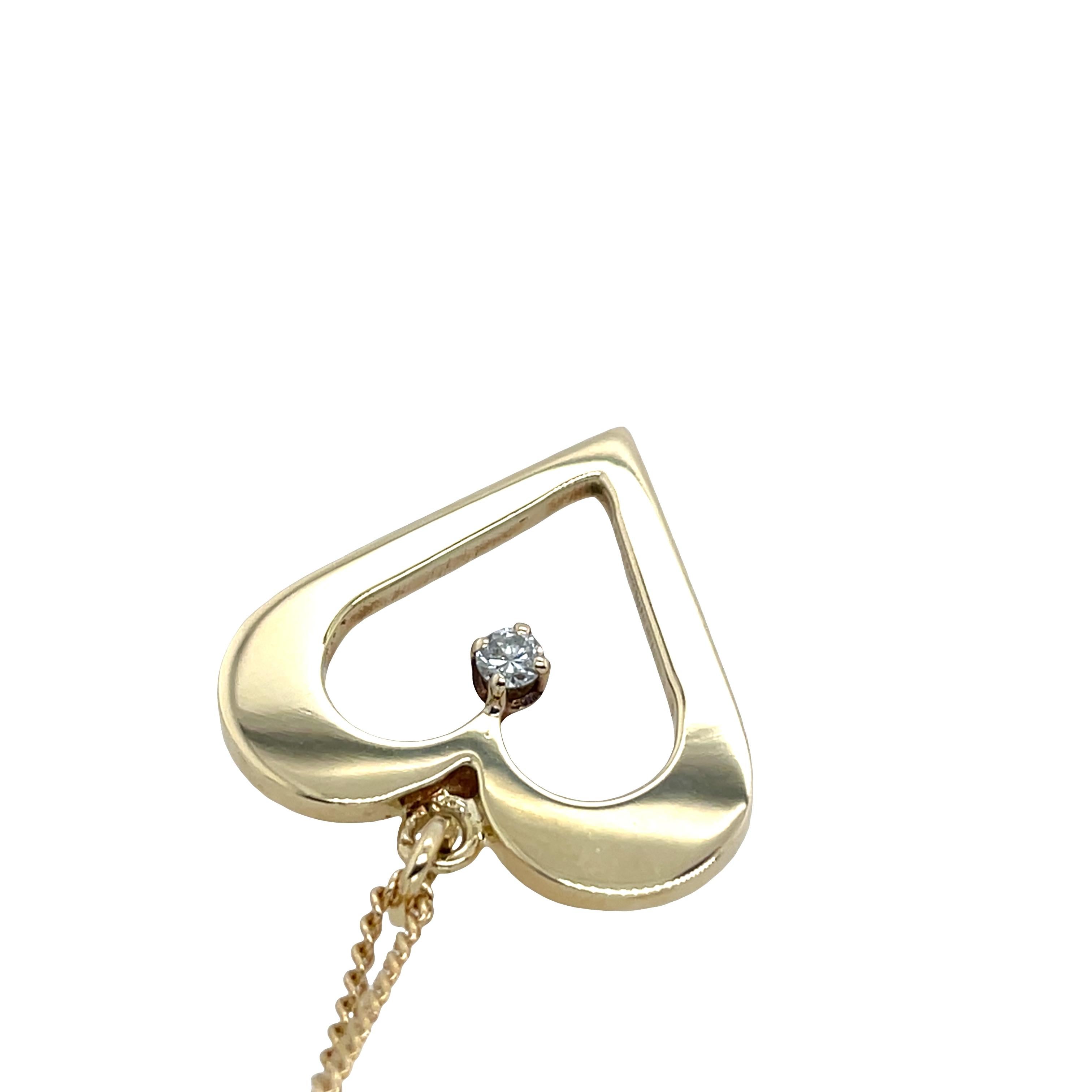 A romantic vintage heart-shaped pendant crafted in 14ct yellow gold, set with a single sparkling diamond at its center. Suspended from a matching 21-inch gold chain.

Total weight: 7.50g
Pendant Dimensions: 23.40mm x 23.70mm x 2mm (depth)
21