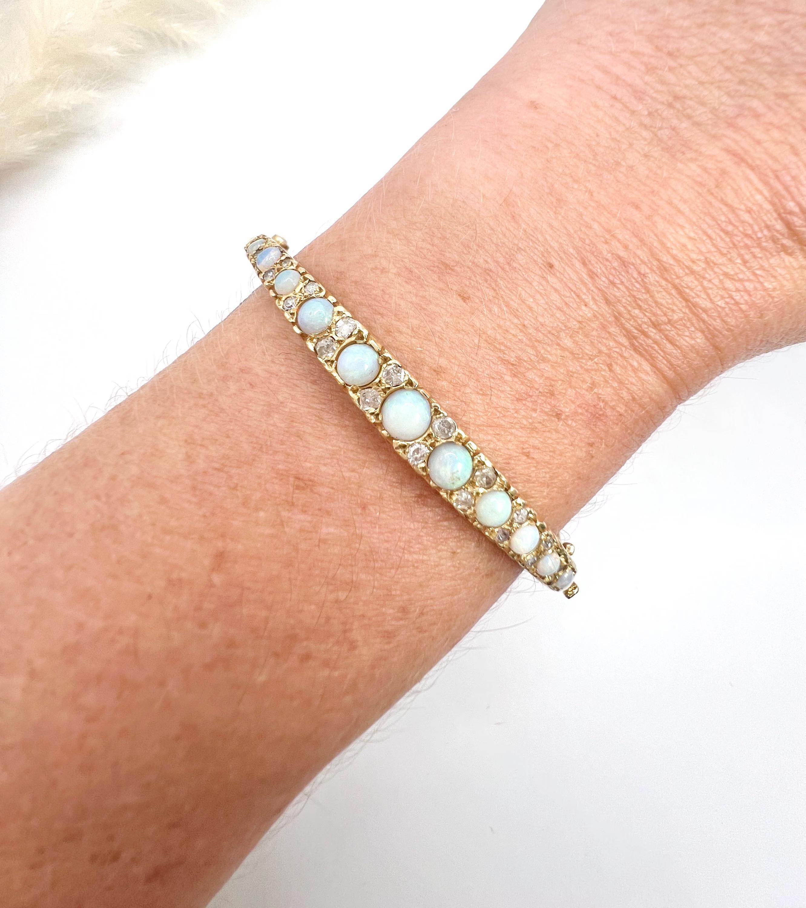 Vintage Opal Bangle

14ct Gold

Circa 1960s

Discover a timeless treasure in this exquisite 14ct yellow gold bangle, beautifully accentuated with a graduated arrangement of luminous opal stones, each radiating its unique play of colour. This vintage
