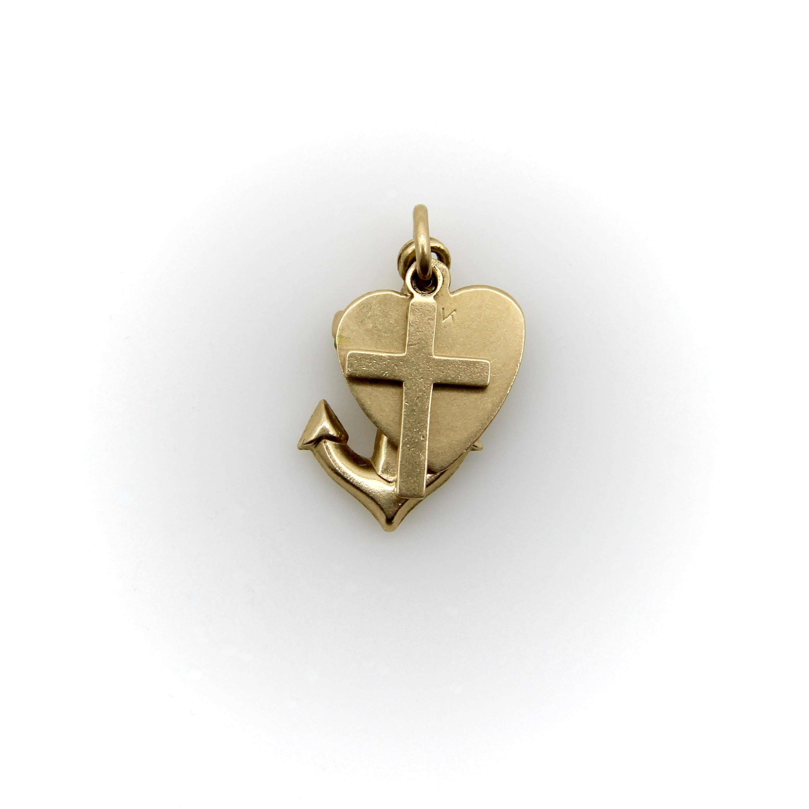 This vintage 14k gold charm trifecta features a cross, heart, and anchor, representing faith, love, and hope. The three charms are stacked and held together by a round bail for a wonderful layered look. The charms have a beautiful matte gold finish.