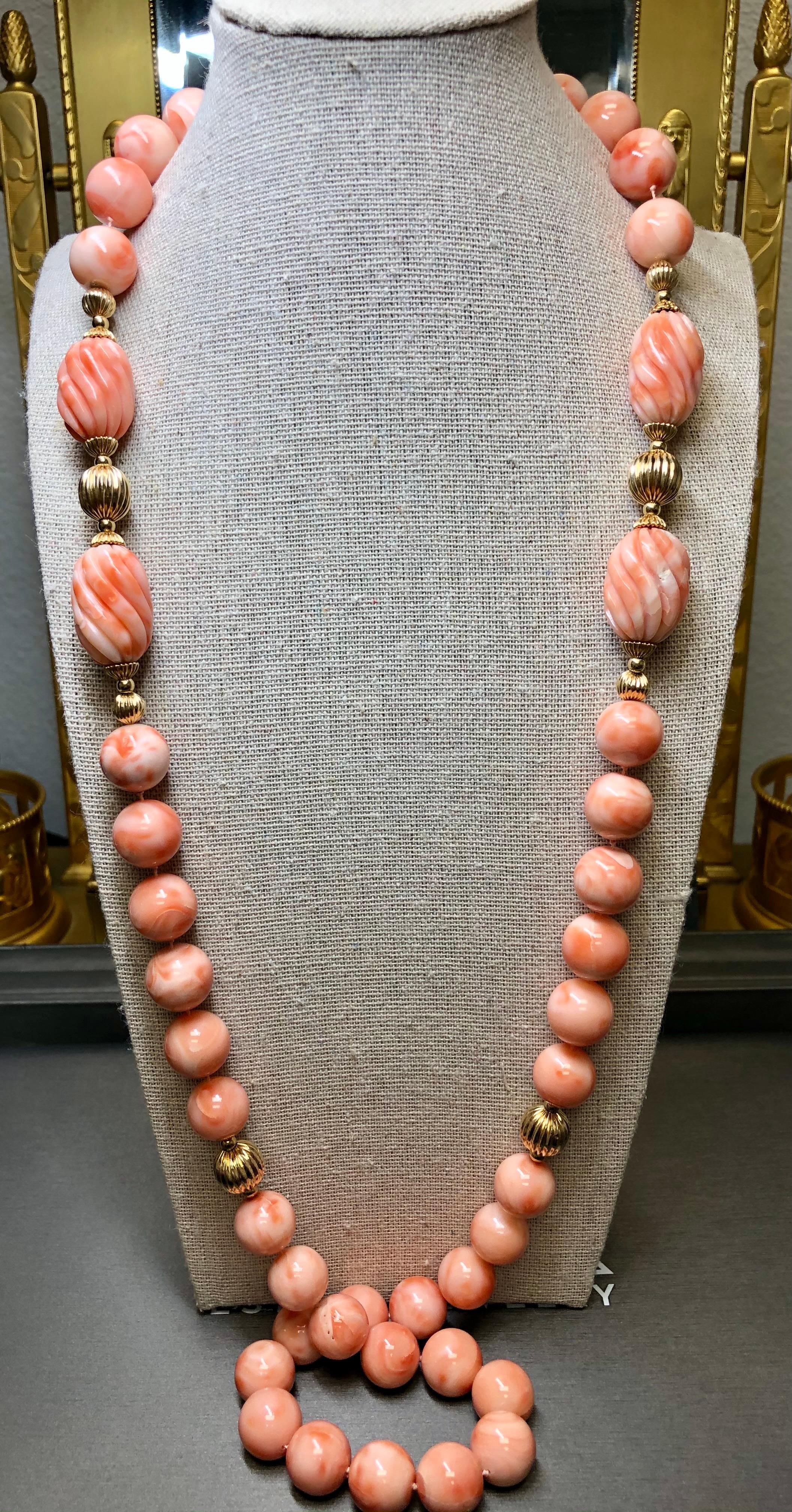 
An incredible coral necklace Circa the 1960’s… and we’ve never see another one like it. It is strung with gorgeous swirling pink and white coral beads and intricately carved coral tubes. Sections are separated by 14K yellow gold rondels and beads.