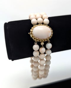 Bracelet vintage en or jaune 14 carats et corail peau d'ange noué à la main