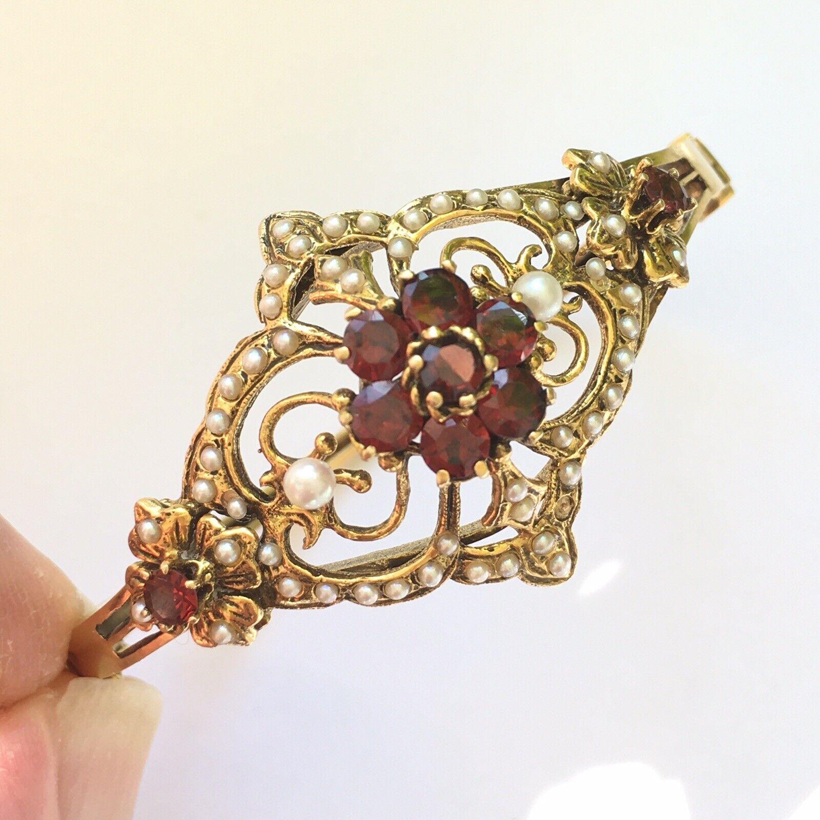  Vintage 14K Art Deco Hinged Bracelet 30s Garnet Seed Pearls

Measurement: Oval hinged 2.25 inch by 2 inch 
Jewels: 9 round Garnet approximately 2.52 Carat Total weight, 1.5mm - 3.0mm white round Seed Pearls (one missing)
Weight: 20.6 gram
Country