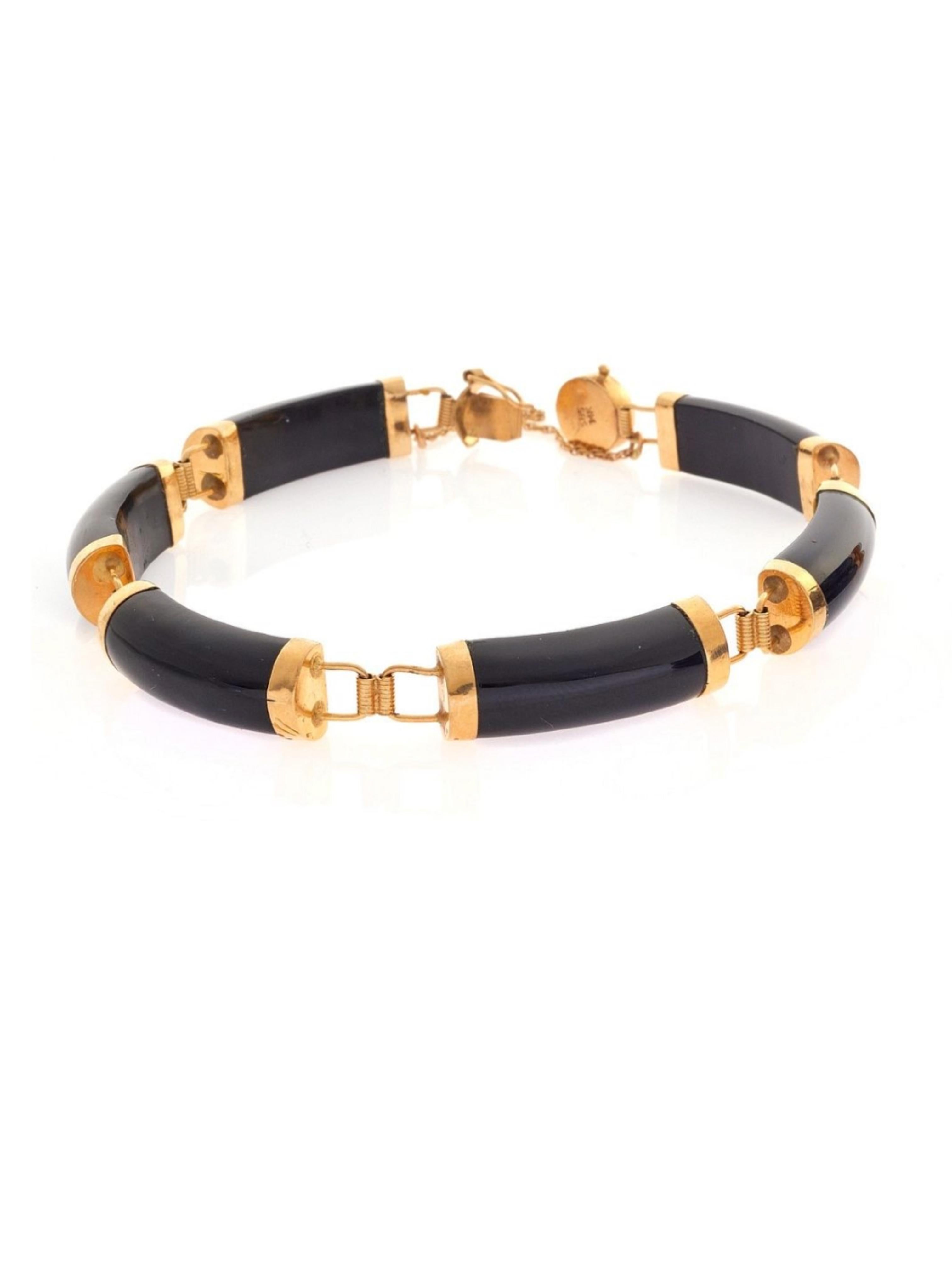 Elevate your style with a touch of good fortune. This bracelet features a round box clasp adorned with the Chinese character for good luck, surrounded by a row of rectangular black onyx segments. The curved onyx stones are topped with 14kt yellow