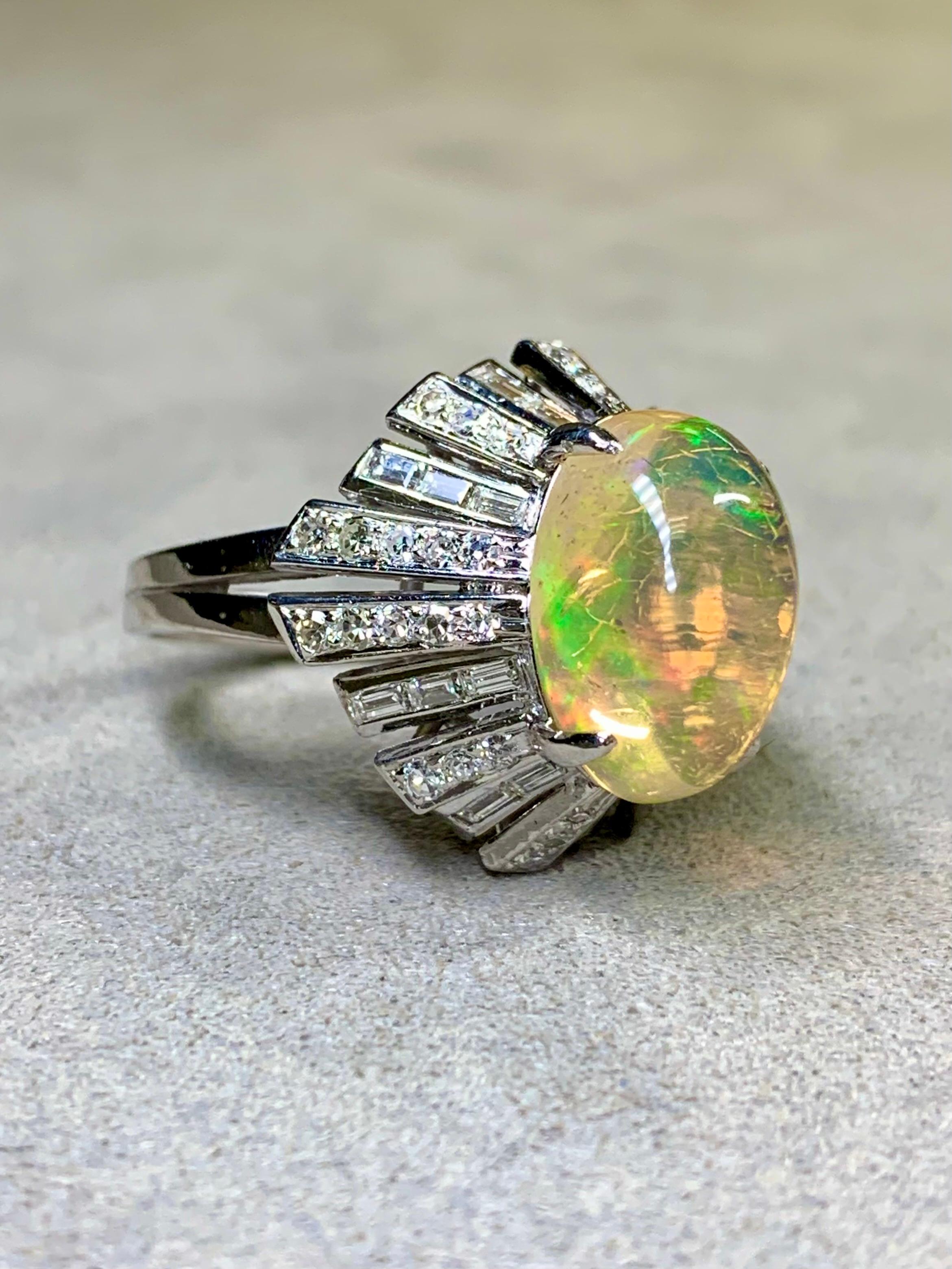 
A spectacular cocktail ring circa the 1960s crafted in 14K white gold and centered by an approximately 5ct cabachon cut Ethiopian opal surrounded by approximately 1.64ctw in both round and baguette diamonds that all average G-H color and Vs1-2
