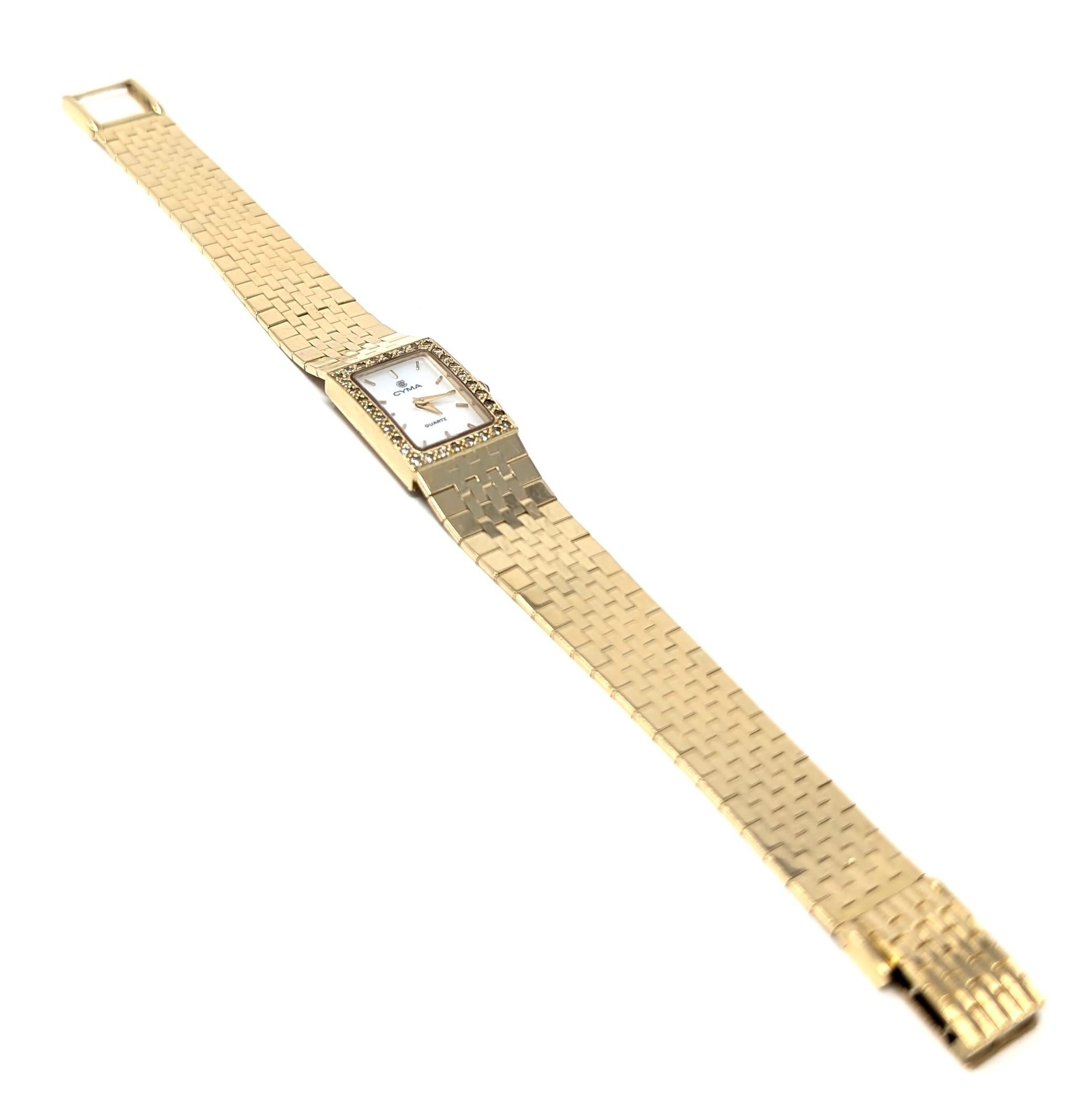Superb vintage CYMA watch, Swiss and quartz with a stunning 14k solid yellow gold band and casing. Features dazzling diamonds, a mother of pearl backing, and a cobalt blue glass crown. The case measures approximately .6 inch in width by .8 inch in