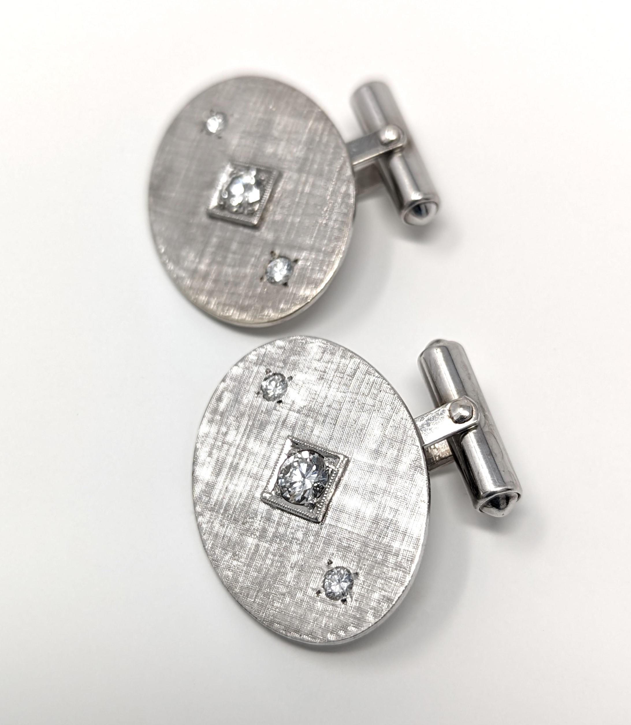 Elegant vintage 14k cufflinks with a modernist brushed gold design. Created in solid 14k white gold with bright and dazzling diamonds. Signed / stamped 14K PAT 2093723 PAT 2544833 on the interior of the cufflinks. The centerpiece measures .75 inch