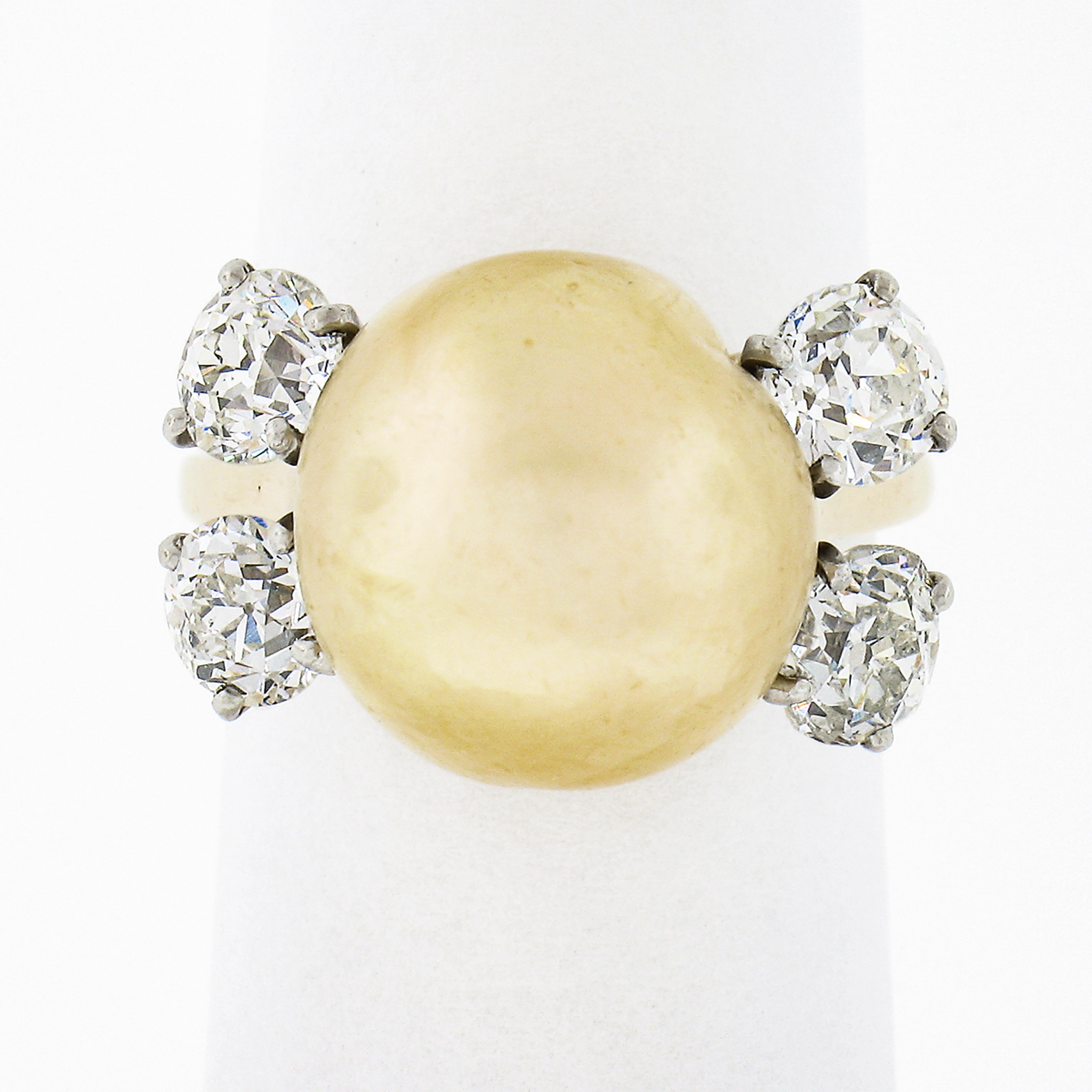 This lovely and elegant vintage ring was crafted from solid 14k yellow gold with solid 14k white gold diamond baskets. This ring features a genuine cultured South Sea pearl that has been certified by GIA. The pearl displays a gorgeous golden yellow