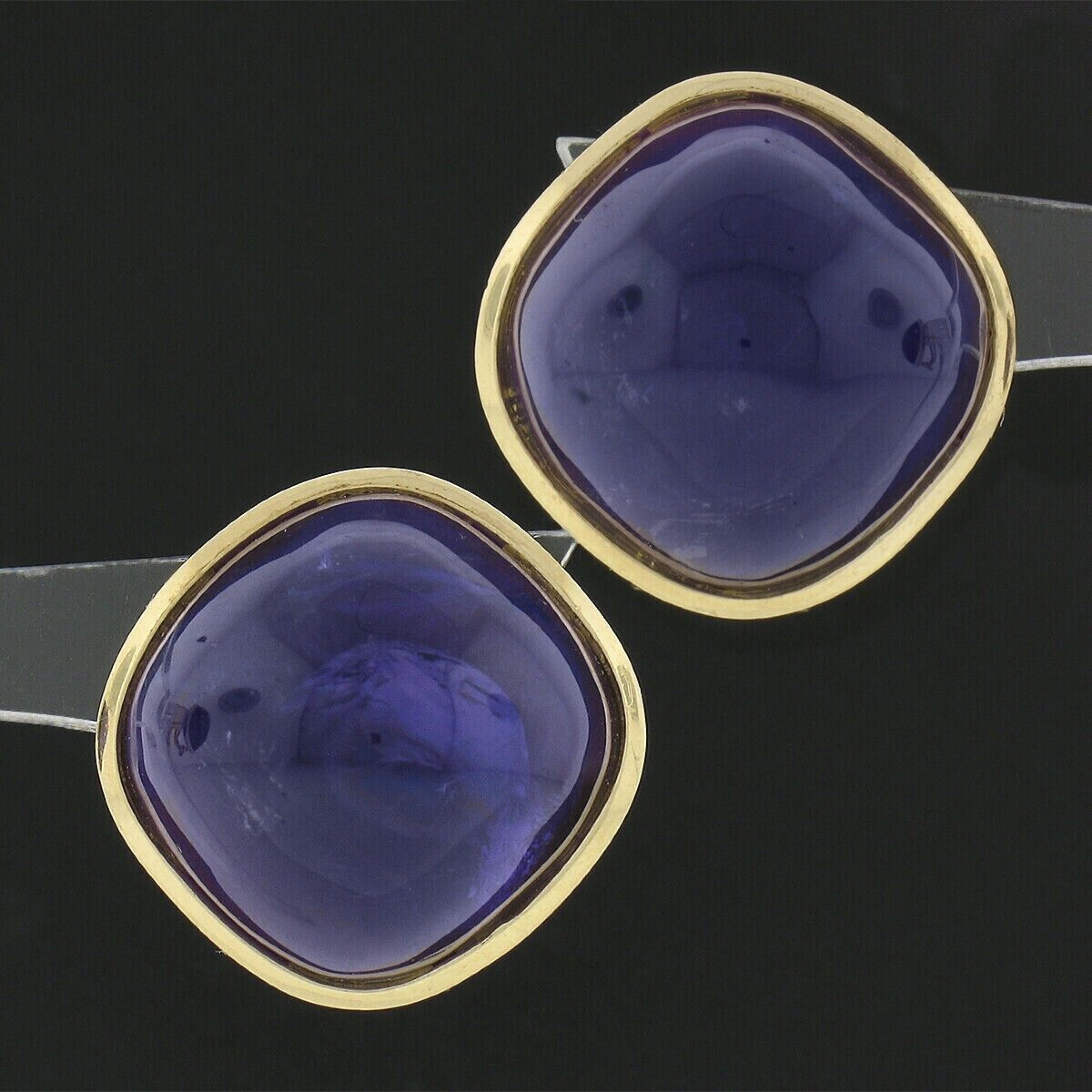 You are looking at gorgeous vintage pair of earrings that are crafted in solid 14k yellow gold and feature a button style that carries large and absolutely amazing amethyst stones at their center. These fine stones are cabochon cut with a domed and
