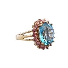 Anello da cocktail vintage in oro 14 carati con topazio blu ovale da 6,00 carati e zaffiro rosa con montatura a halo