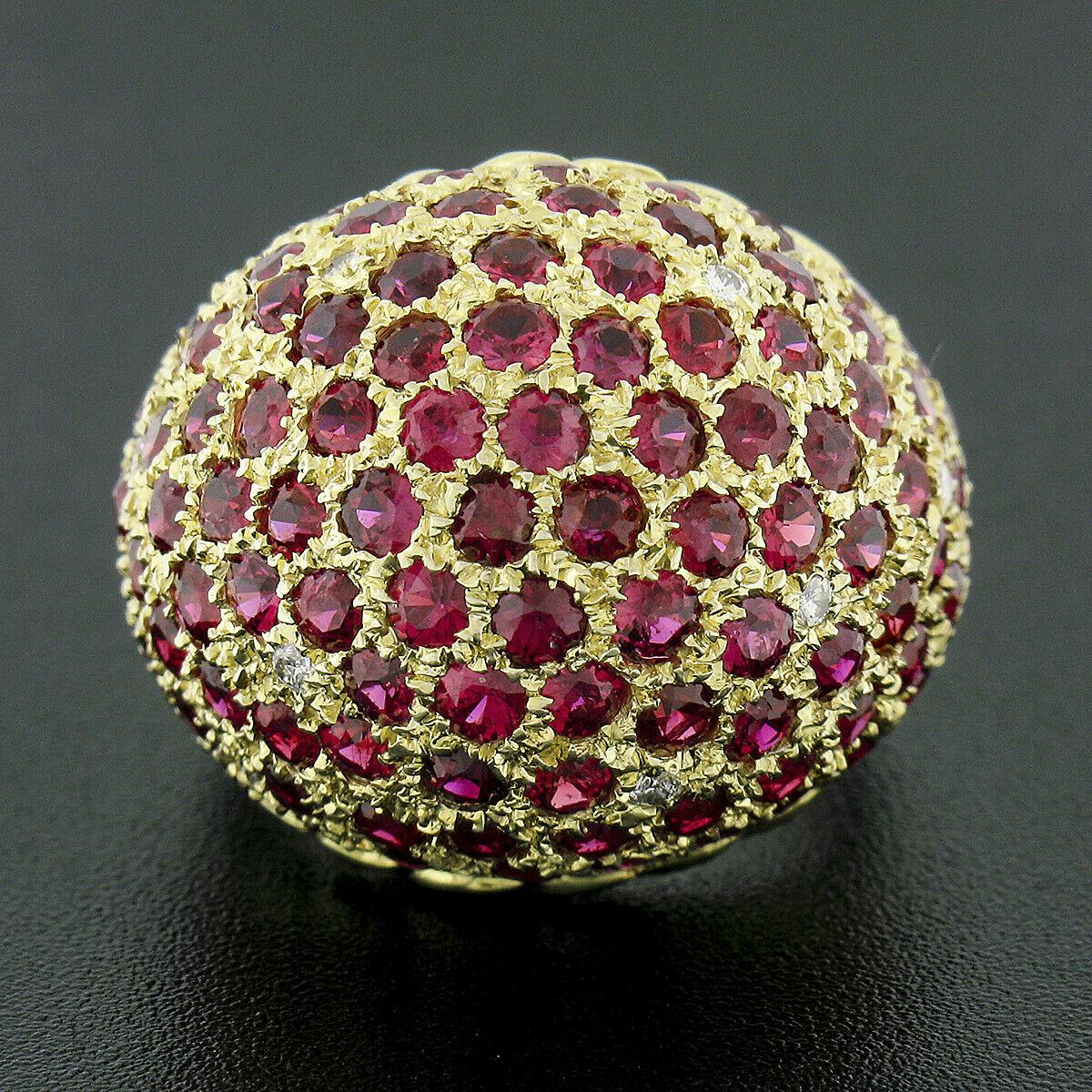 This magnificent vintage bombe ring was crafted from solid 14k yellow gold and features a large domed top of which is drenched with approximately 6.00 carats of fine quality rubies throughout. The round brilliant cut rubies are neatly pave set and