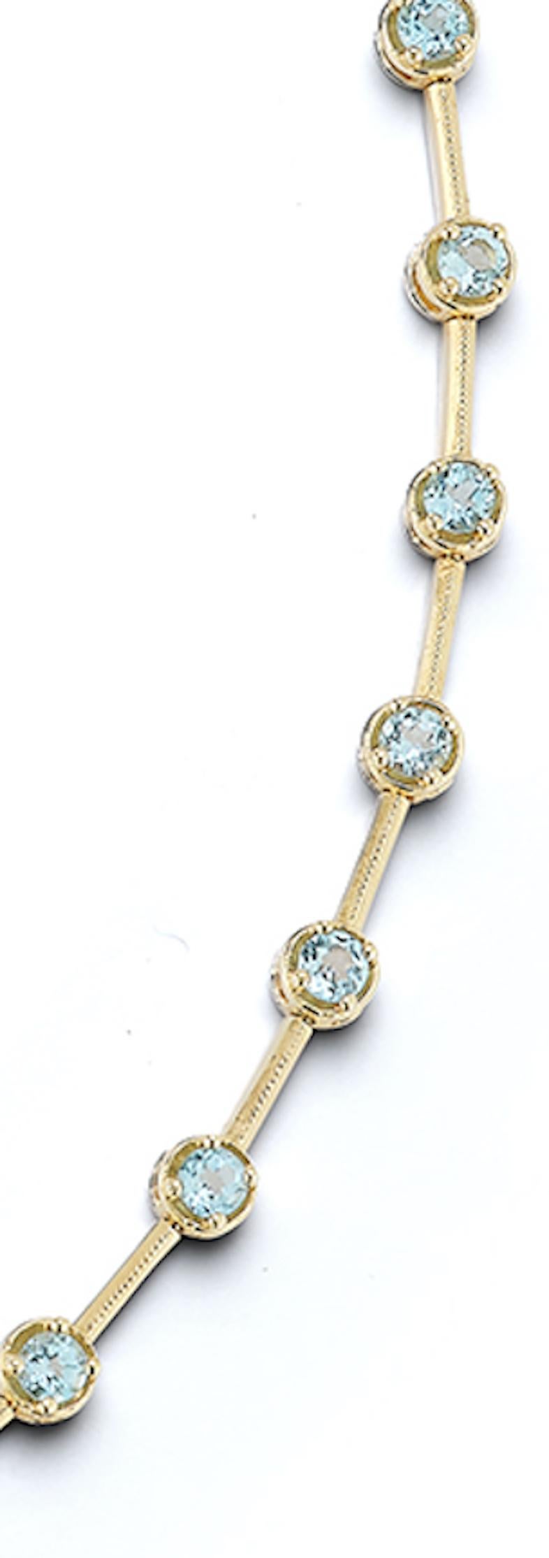 This retro vintage 14k gold necklace is elegant and unusual. Each bezel and prong set light blue topaz is divided by a gold bar creating an unexpected collar style station necklace. Bar style links sit at the back with 28 bezel set topazes along the