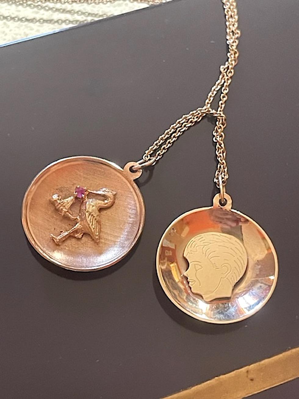 The perfect Mother's Day Gift for a new mom or one that wants to represent her child. The vintage disc charm showcases a stork holding a bundle with a prong set pink sapphire.

The back of the charm may be engraved with a name, message and/or