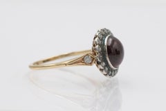 Vintage 14k gold and silver ring with a cabochon-cut garnet and diamonds
