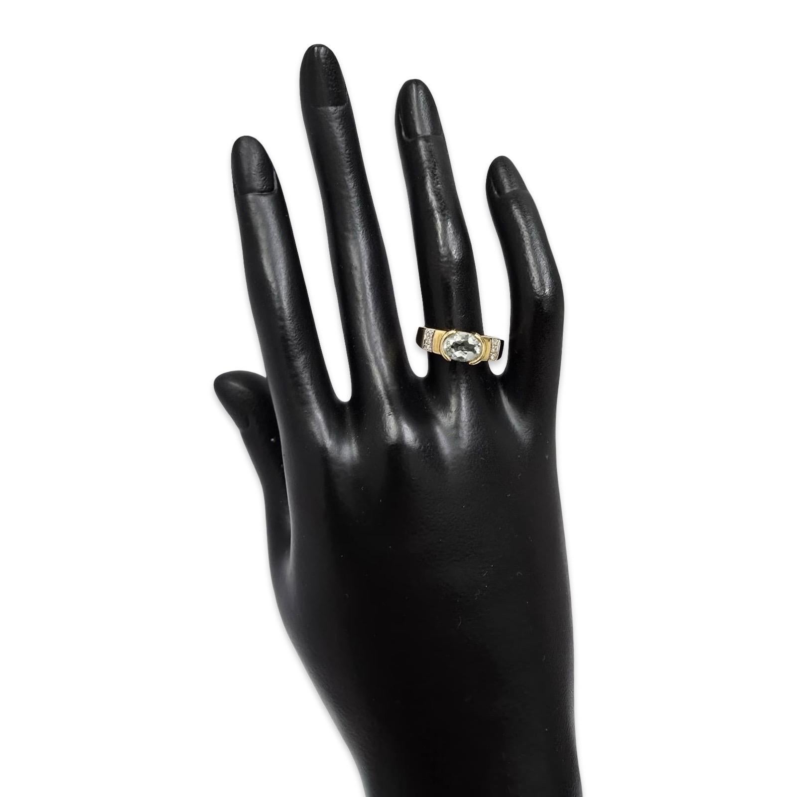 Un sorprendente anello modernista d'epoca in oro 14K che mette in mostra un'acquamarina chiara splendidamente sfaccettata di circa 6 × 8,35 mm, fissata in una montatura a mezzo castone. La pietra centrale è incorniciata da diamanti brillanti su ogni