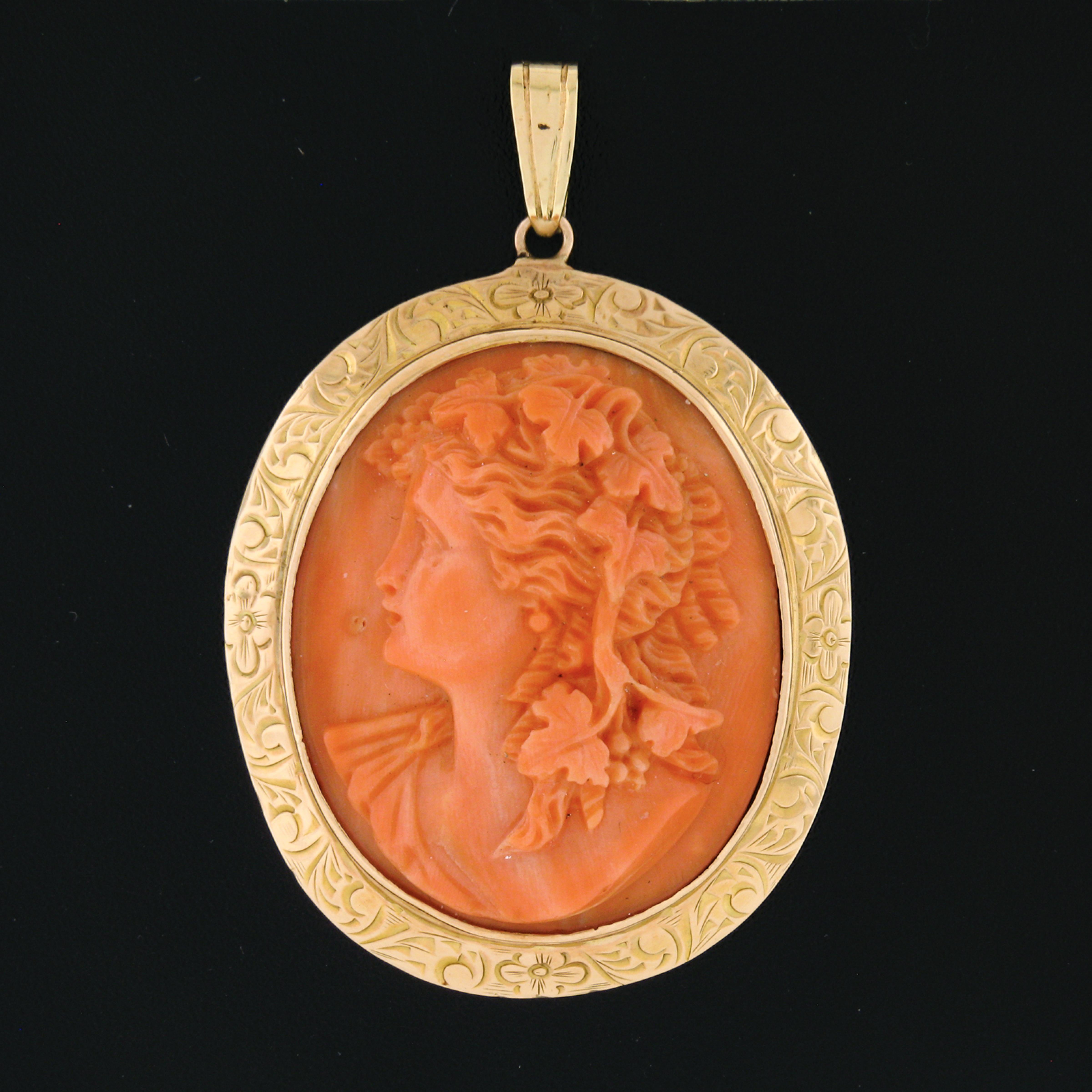 Here we have an outstanding vintage pendant that was crafted from solid 14k yellow gold. It features a large and magnificent piece of natural coral that is bezel set at its center with a gorgeous and rich salmon pink color, and has been masterfully