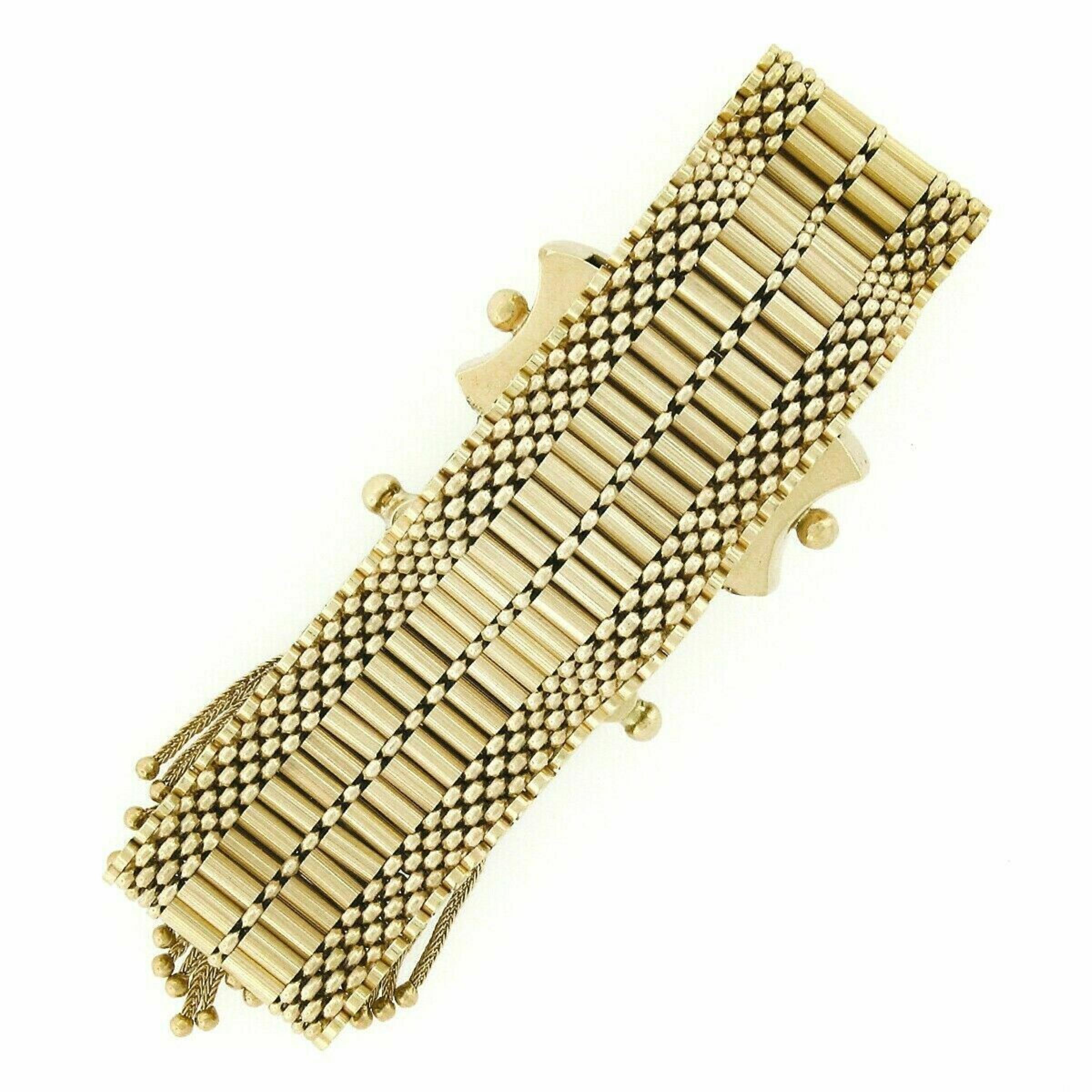 You are looking at a gorgeous vintage strap bracelet that was crafted in solid 14k yellow gold featuring a magnificent Victorian revival design. The wide strap is constructed from neatly set round and bar links in which sit beautifully with a silky