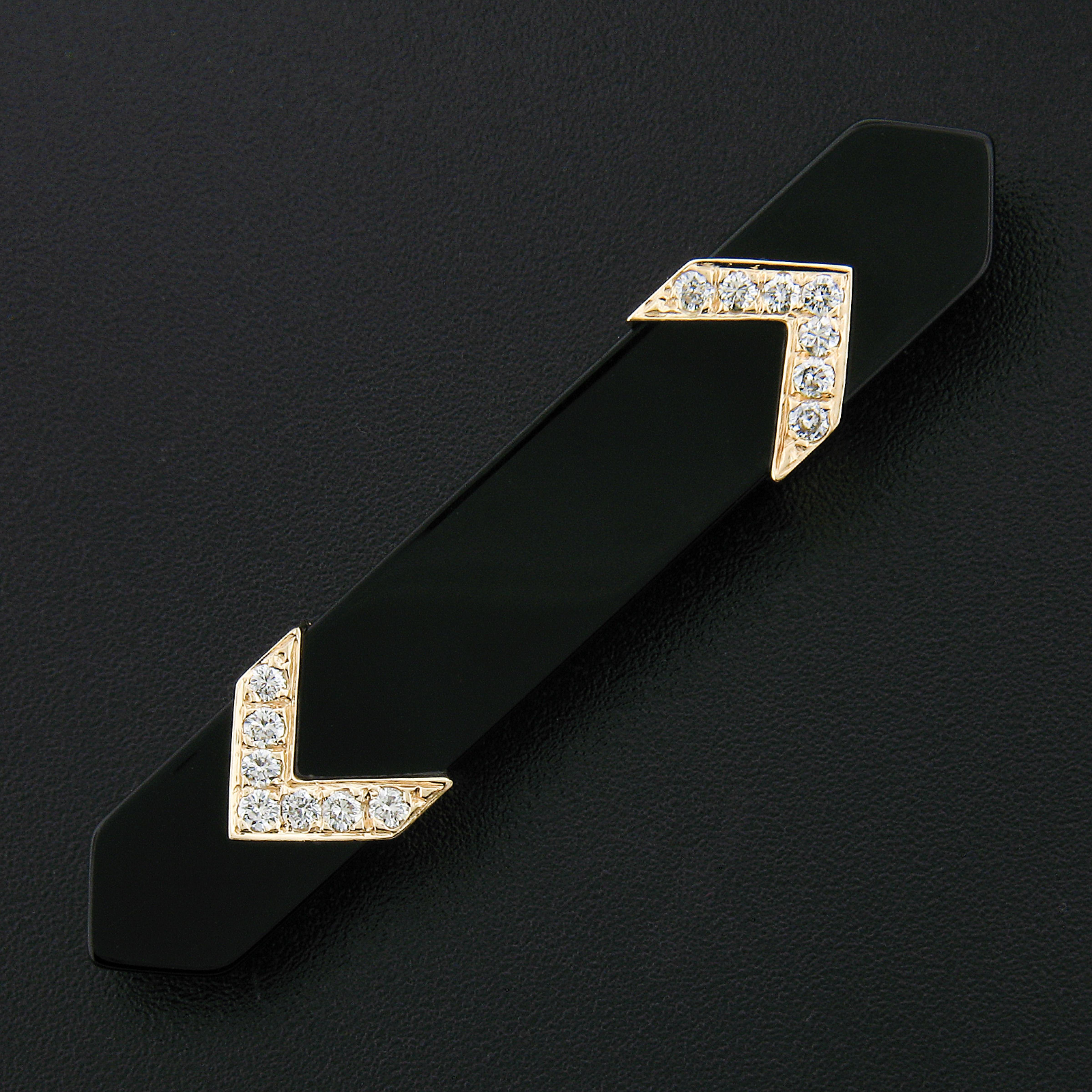 Here were have a vintage bar pin/brooch that is constructed from a highly polished, genuine custom cut black onyx stone. The black onyx stone is accented with very fine quality diamonds that are pave set on 2 14k yellow gold arrows on top of the