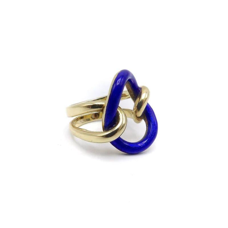 Il s'agit d'une audacieuse bague vintage en 14k et émail bleu, magistralement façonnée en un nœud d'amoureux. La tige de l'anneau est une boucle ouverte qui s'entrecroise avec la pièce centrale en émail bleu, ressemblant à un maillon d'une chaîne.