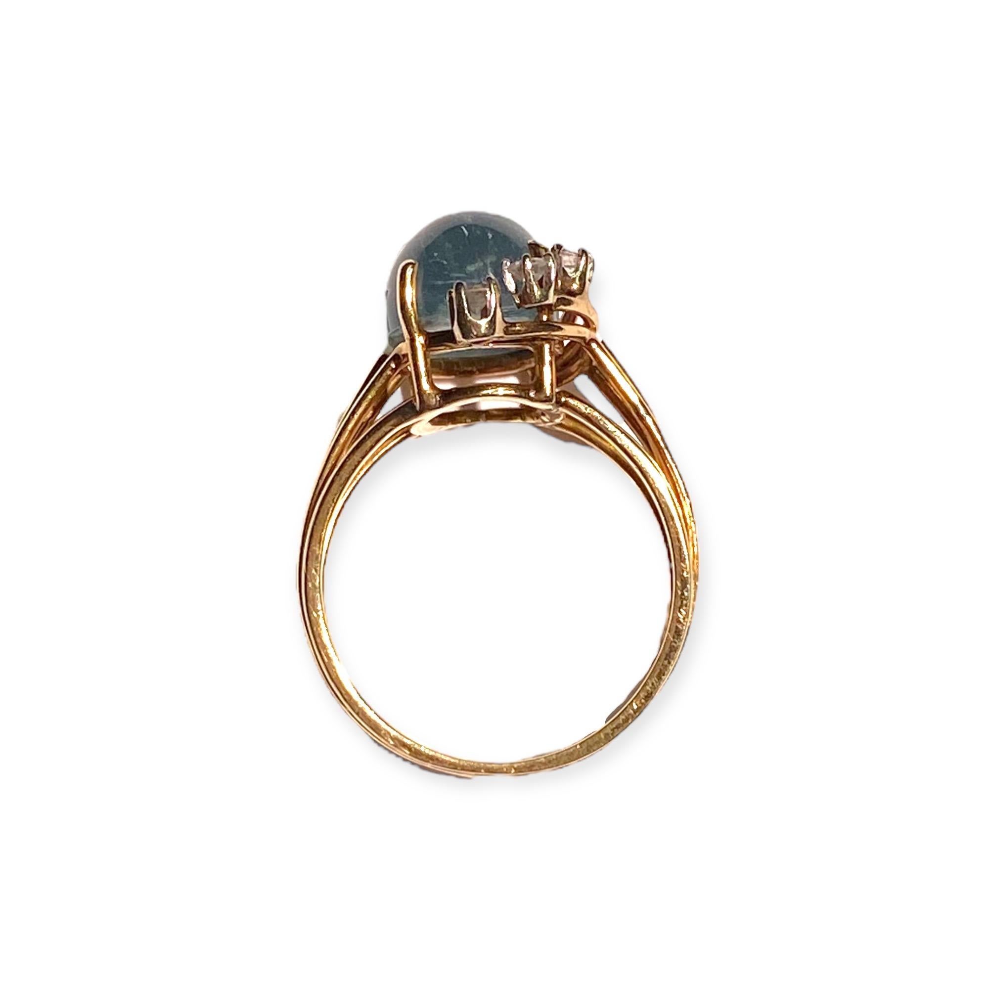 Crafted in 14K yellow gold, the ring features an oval cabochon cut aquamarine accented by three diamonds, supported by split shoulders, completed by a three millimeter wide band.
Aquamarine: 13 mm H x 9 mm W x 6.4 mm D.  Estimated weight: 5.4ct.
3