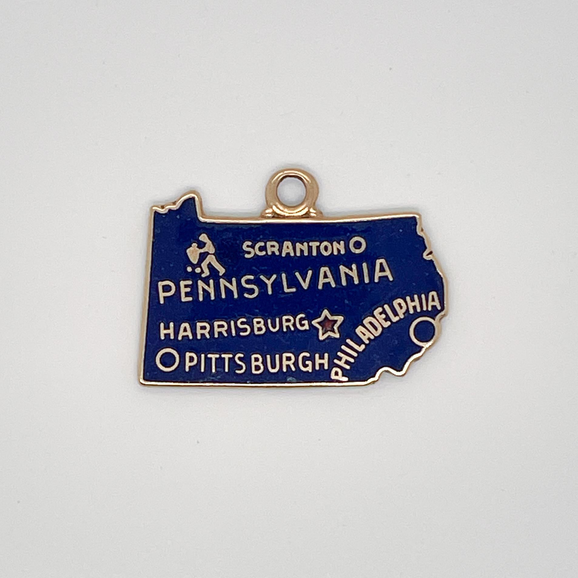 A vintage 14 karat gold charm for a charm bracelet. 

In the shape of a map of State of Pennsylvania and decorated in blue enamel. 

It is inscribed with the names of the cities of Scranton, Pennsylvania, Harrisburg, Pittsburgh and Philadelphia. 