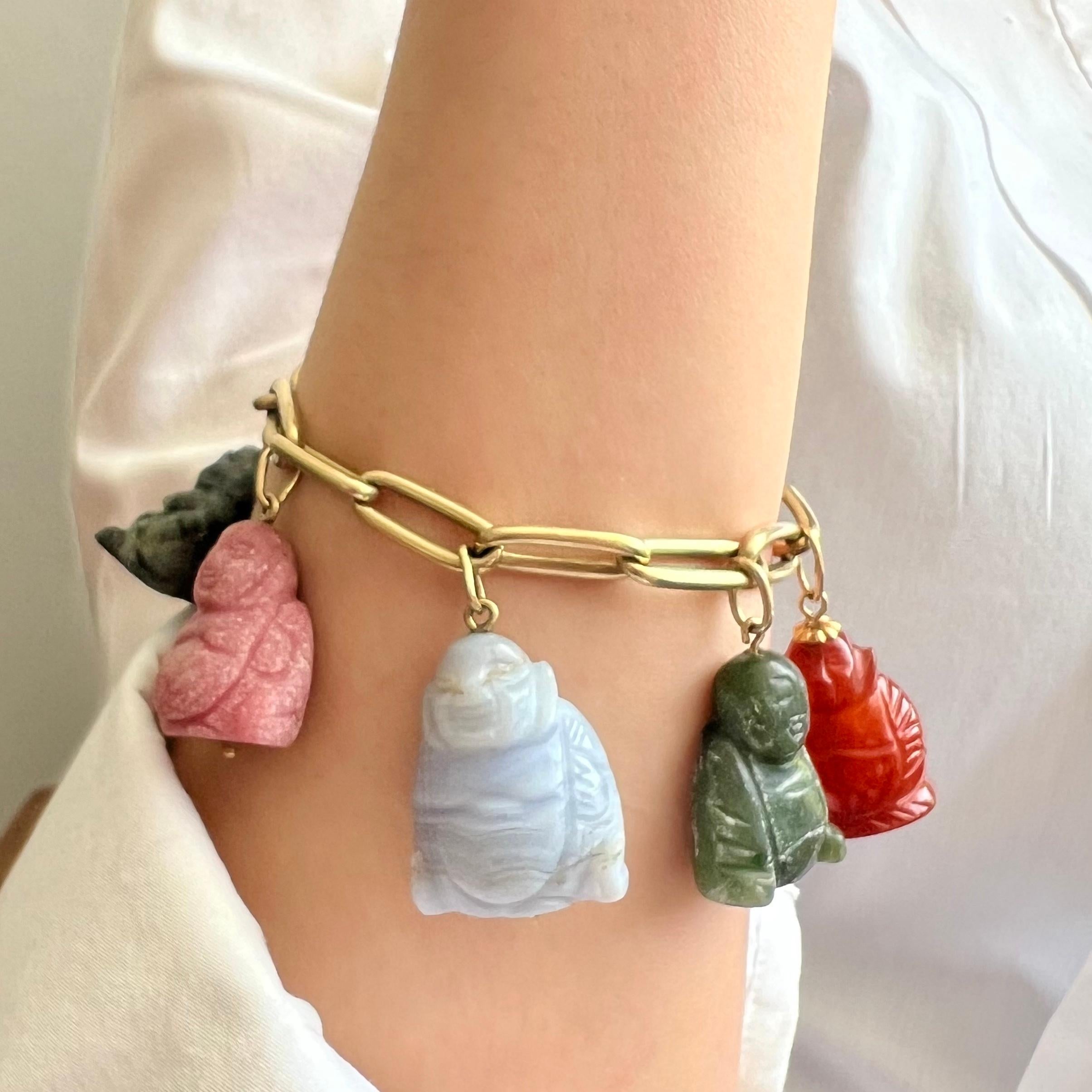 This charm bracelet is superb with these six Buddha's and a Dutch coin attached to a gold closed forever link chain. The six colorful Buddha's consist of different types of gemstones including; jade, rhodonite, blue lace agate and moss agate. The
