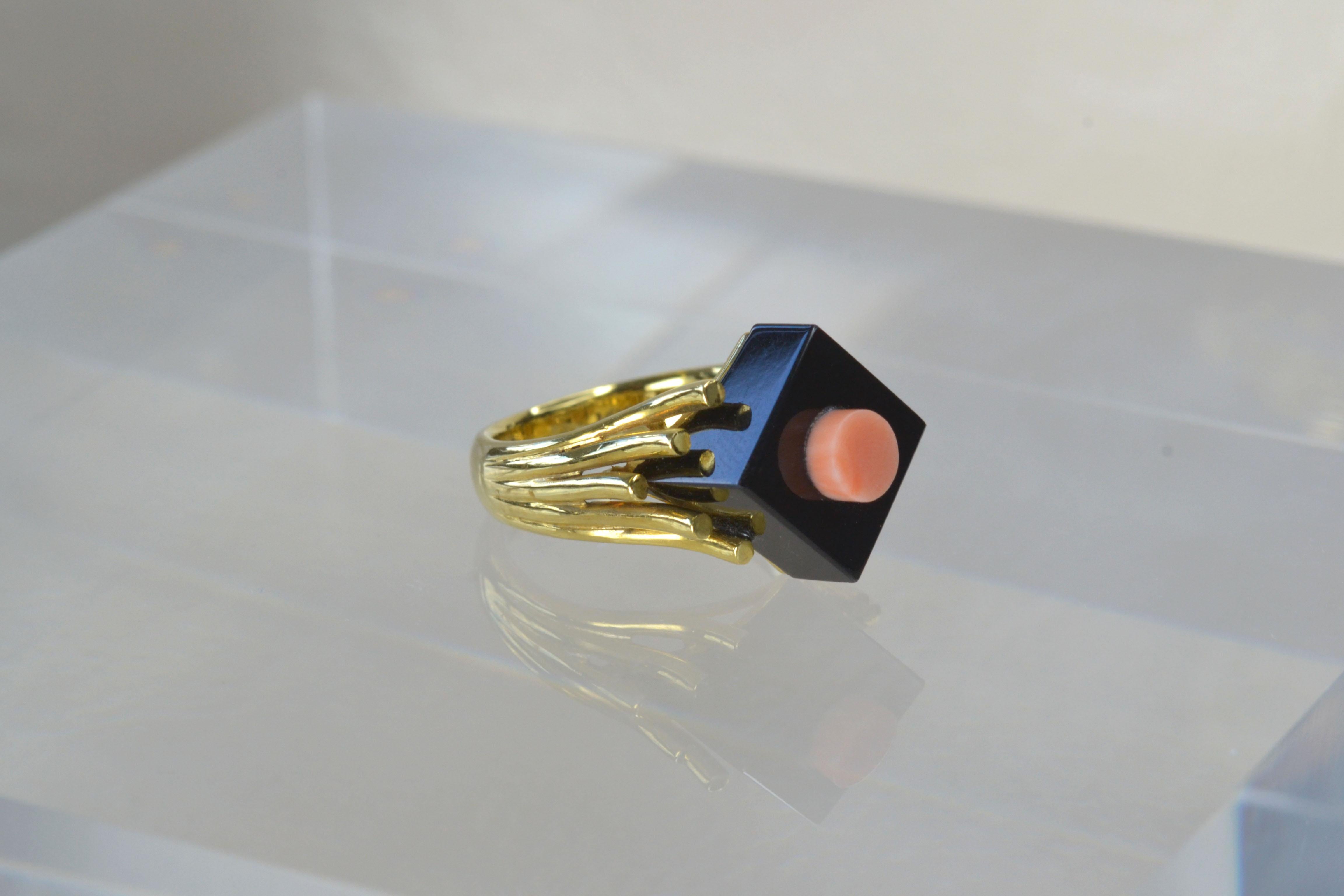 Vintage 14k Gold Coral & Onyx Geometric Ring One-of-a-kind

This funky, vintage ring displays 14k gold tentacles climbing up the brilliant onyx, which bears a gorgeous coral shape in its centre. This truly is a stunning statement ring and it