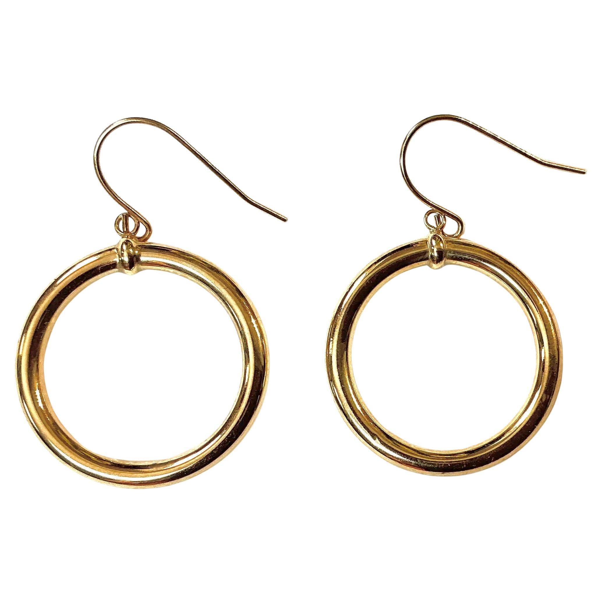 Vintage 14K Gold Dangle Hoop Earrings. Each earring features a classic circular hoop suspended from a delicate wire hook, allowing for graceful movement and subtle shine with every wear. Pair weighs 1.84 grams TW and measures 1.5'L x 1