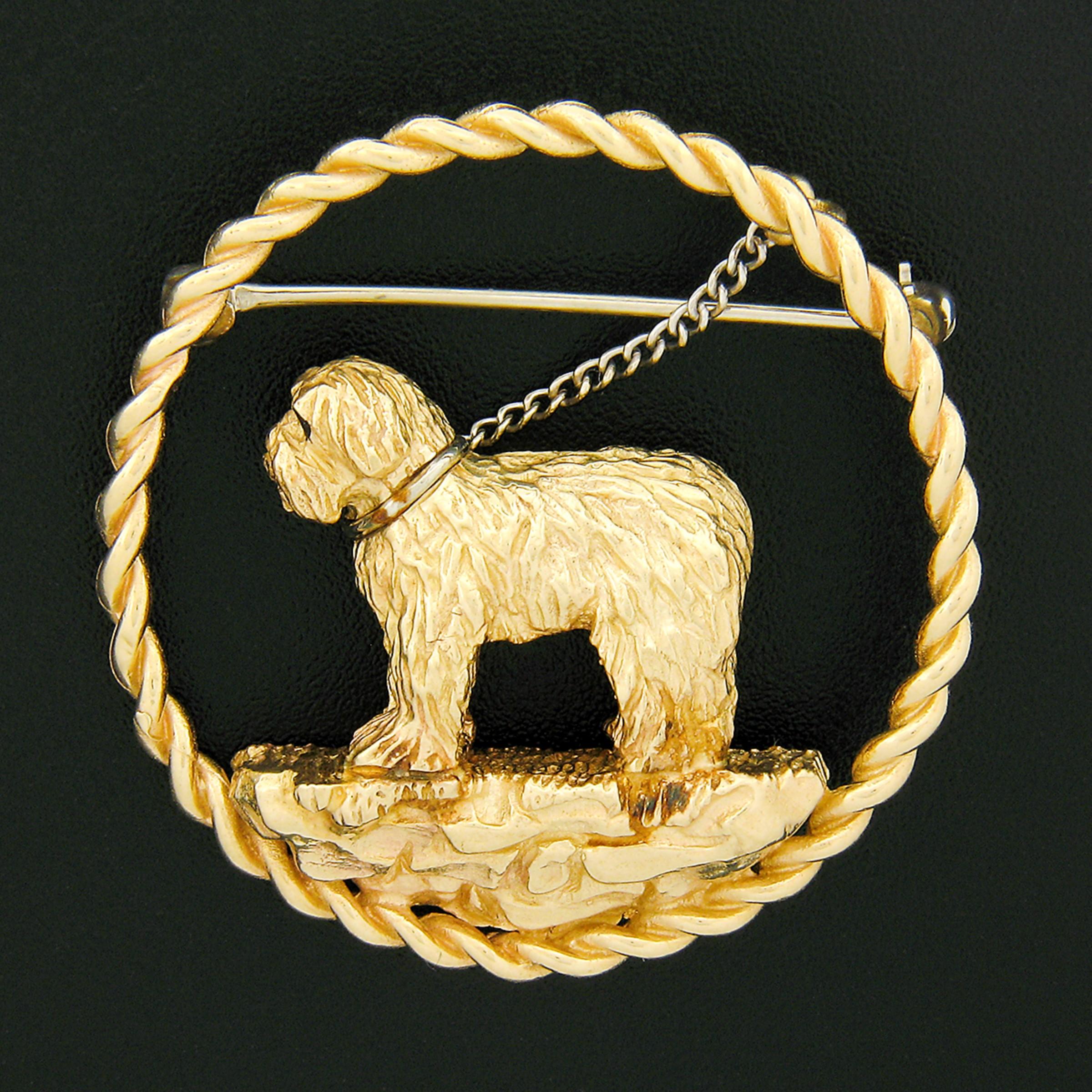 This outstanding vintage pin/brooch is crafted in solid 14k yellow gold and features an adorable Maltese dog standing on a ledge in a lovely open circular frame. This heavy and well made brooch pin shows absolutely incredible detail throughout that