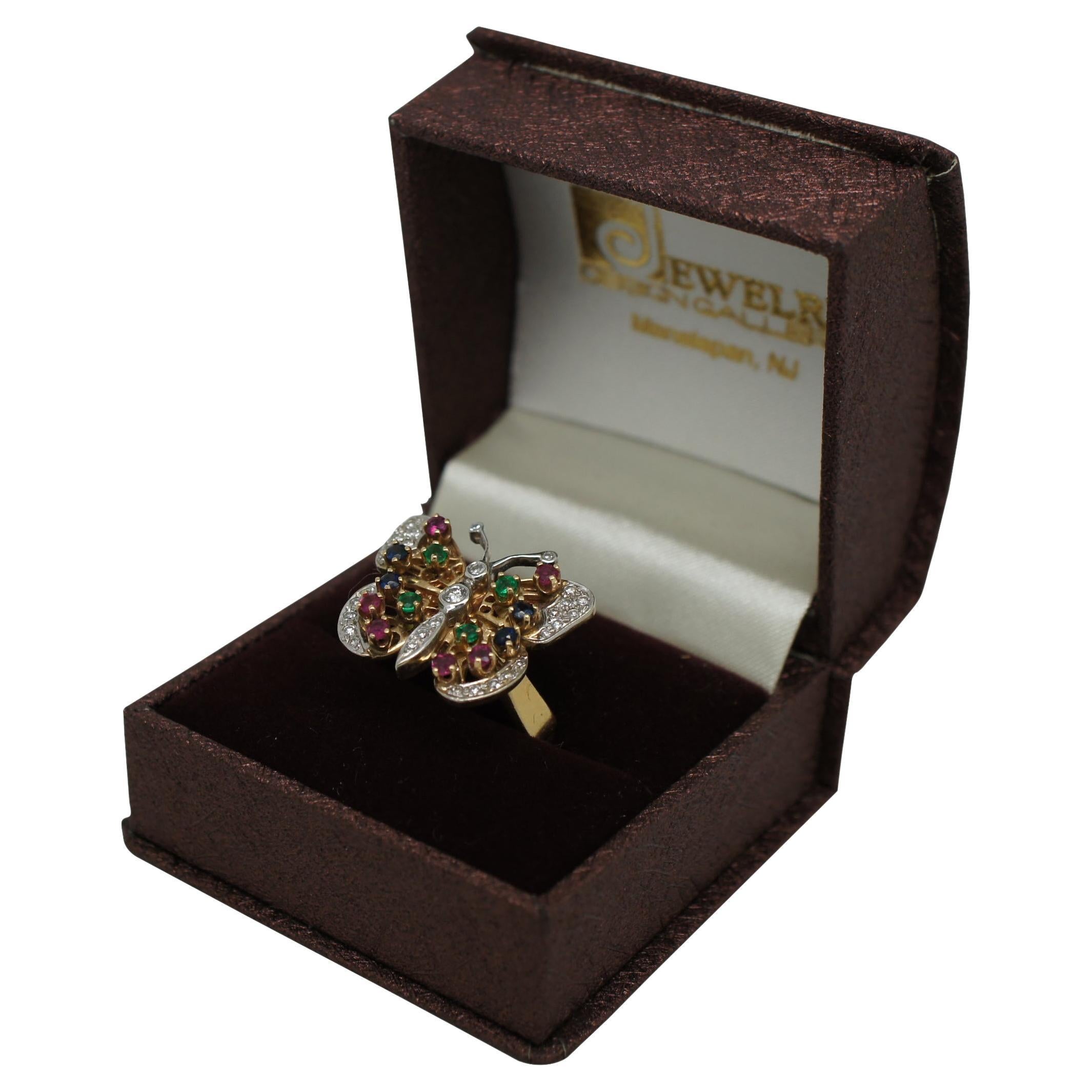 Vintage 1970s/1980s 14k yellow and white gold ring in the shape of a butterfly decorated with diamonds, emeralds, rubies and sapphires.

Size 8.25 / Setting -  1” x 0.75” (Width x Depth)