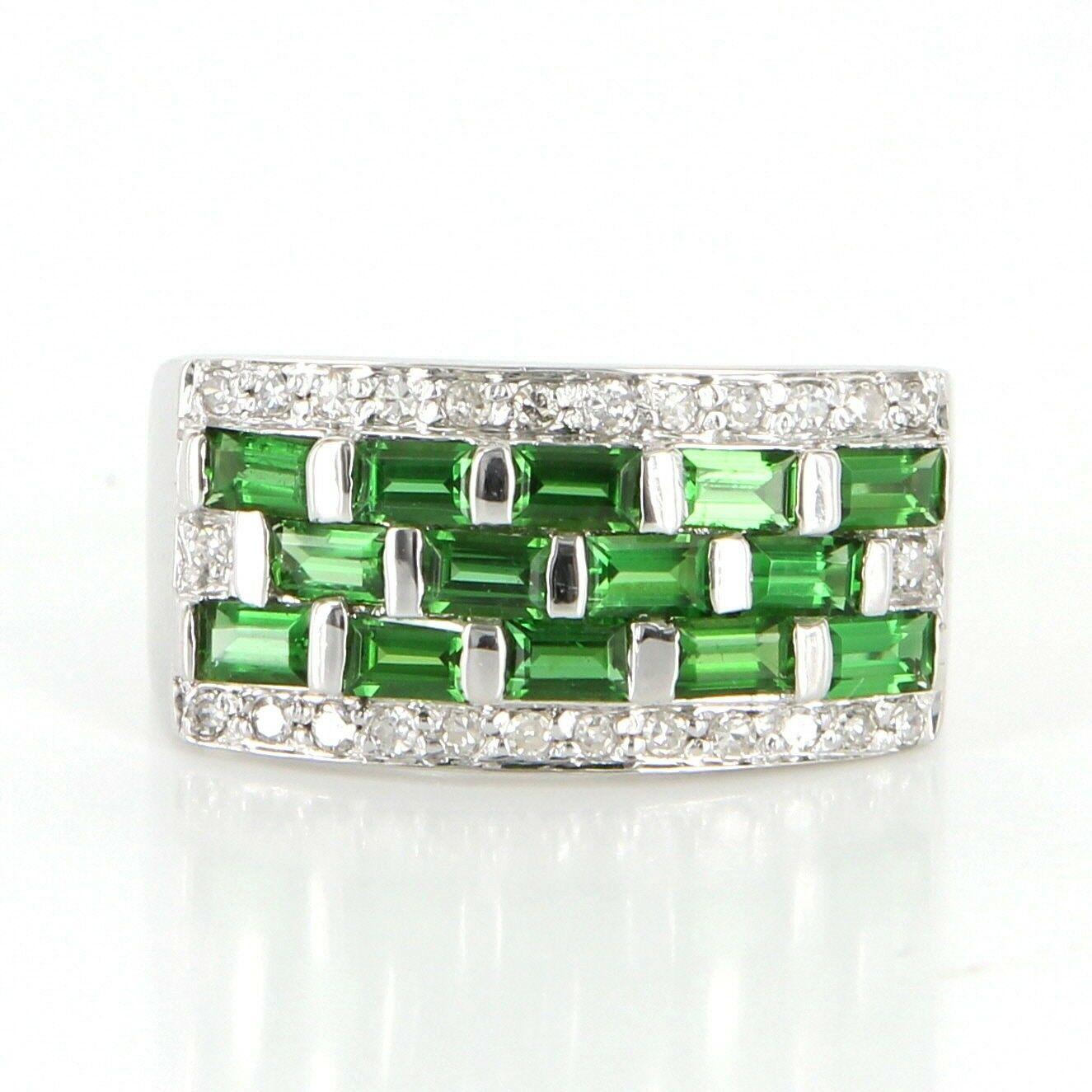Offered for sale is a truly superb vintage cocktail right hand ring, crafted beautifully in 14 karat white gold.

The band is set with emerald cut tsavorite garnet totaling 1.12 carats estimated and an estimated .23 carat single cut diamonds in an