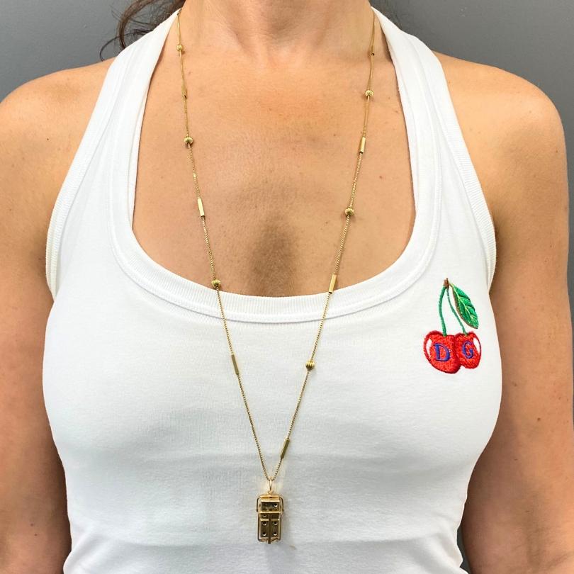 Ce collier vintage allie un design ludique à un travail d'orfèvre classique. Le pendentif vintage en or 14 a la forme d'une petite cage qui contient deux dés miniatures à l'intérieur. Le pendentif s'ouvre pour révéler le dé amovible, dont les