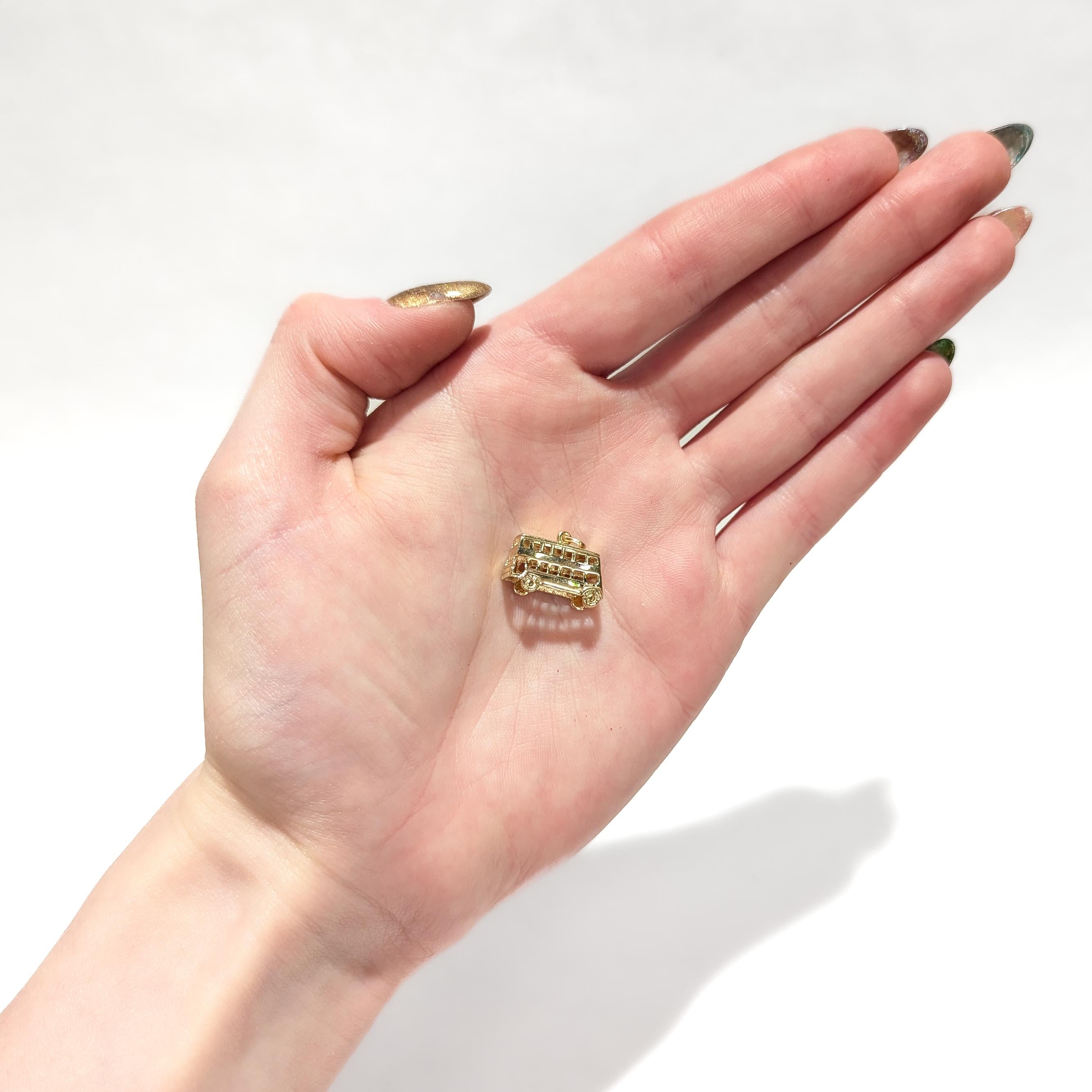 A fine vintage gold charm for a charm bracelet.

In 14 karat yellow gold.

In the form of a double decker bus. 

With an integral bail and jump ring to the roof of the bus.

Simply a wonderful charm!

Date:
20th Century

Overall Condition:
It is in