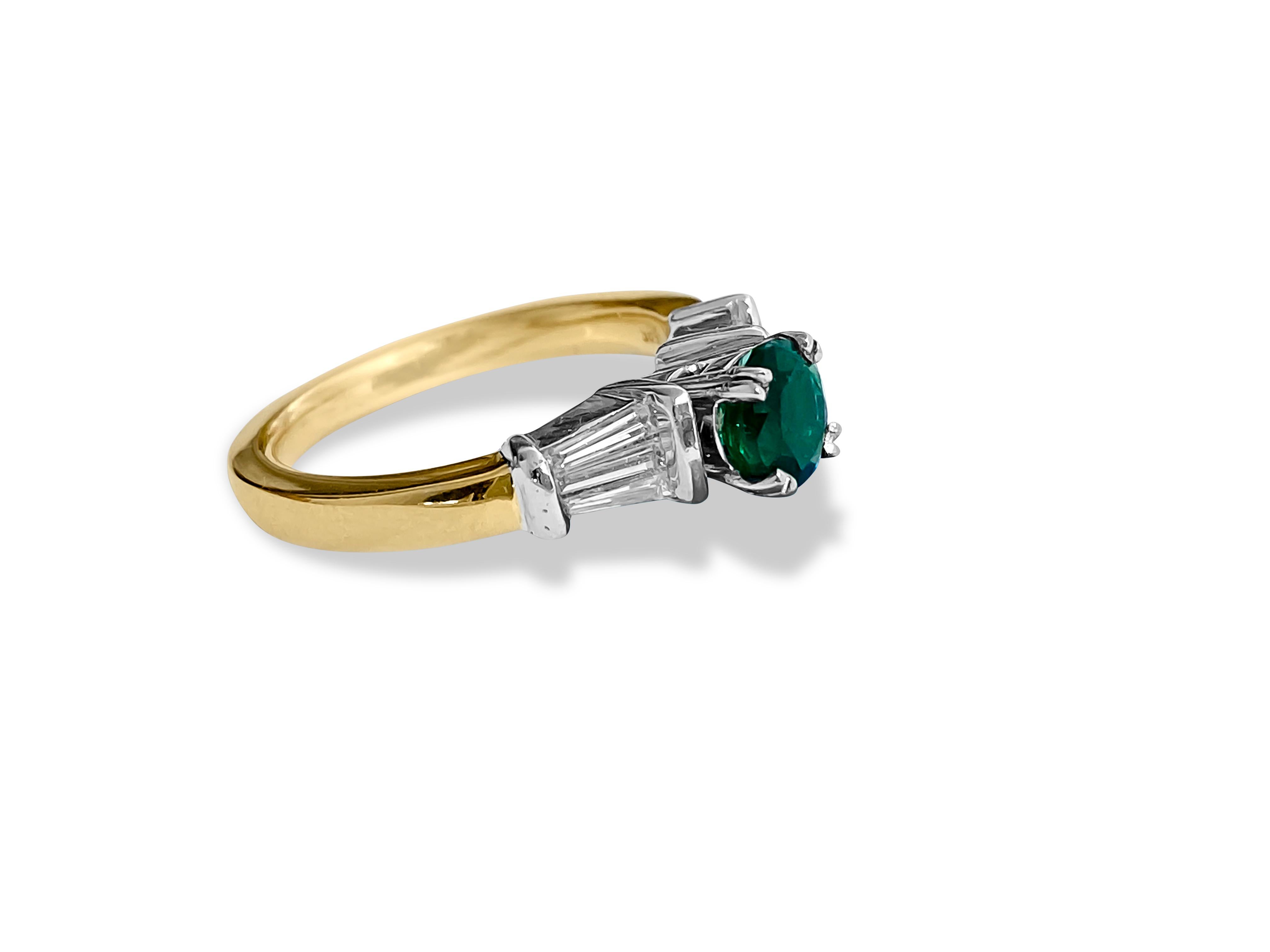 Fashioned from radiant 14k yellow gold, this captivating engagement ring features a stunning 1.05 carat round-cut emerald, a natural gem mined from the earth, gracing its center. Enhancing its allure, shimmering baguette-cut diamonds totaling 1.25
