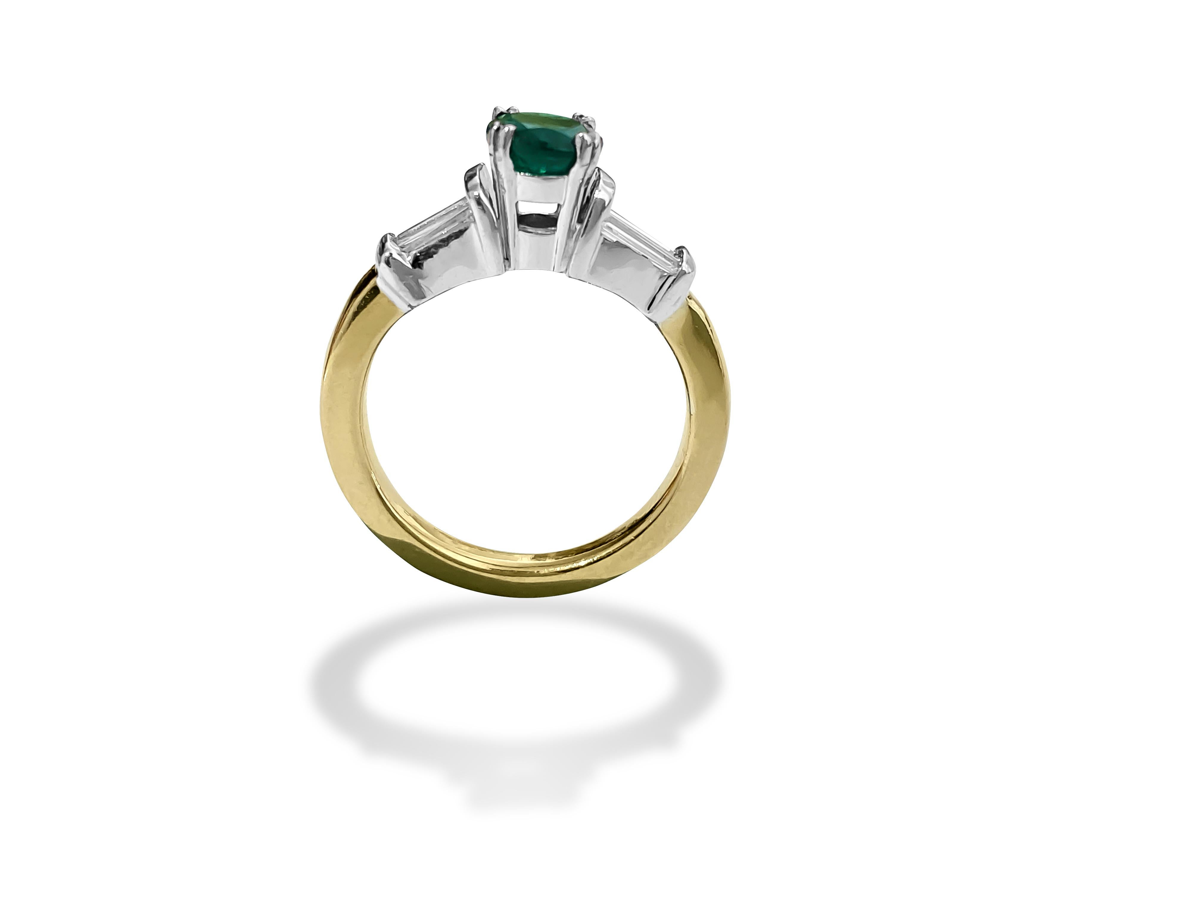 Fashioned from radiant 14k yellow gold, this captivating engagement ring features a stunning 1.05 carat round-cut emerald, a natural gem mined from the earth, gracing its center. Enhancing its allure, shimmering baguette-cut diamonds totaling 1.25