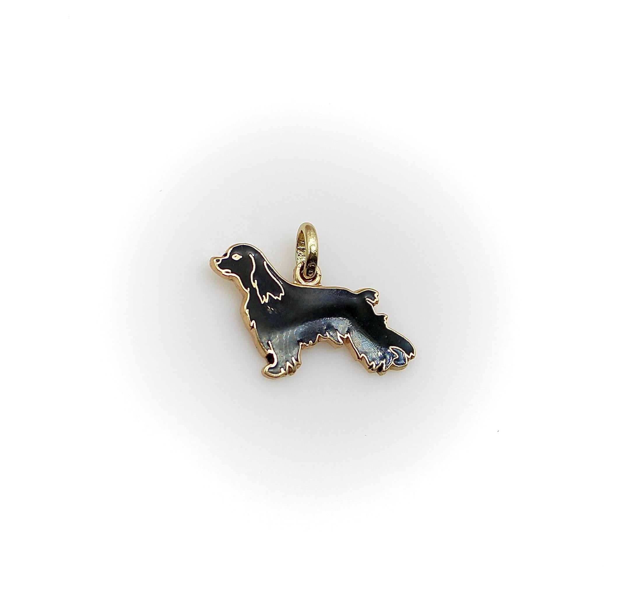 Made in 14k gold with enamel details, the dog in this charm is a Springer Spaniel, shown in profile in a proud pose, like a show dog. The outline of the dog is highlighted in gold, and  black enamel butts up against the gold to create a pattern of