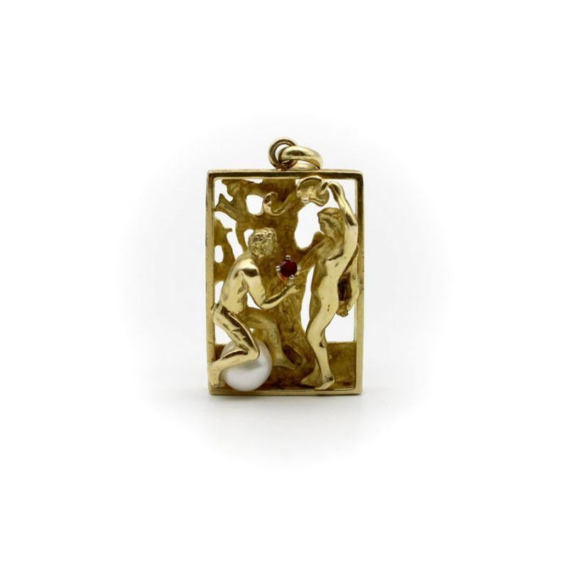 14K Gold Figural Adam and Eve Pendant with Ruby and Pearl

In a 14k gold rectangular pendant, Adam and Eve are framed under the Tree of Knowledge as the snake looms in the branches. The image is rendered in three dimensions, much like a diorama or