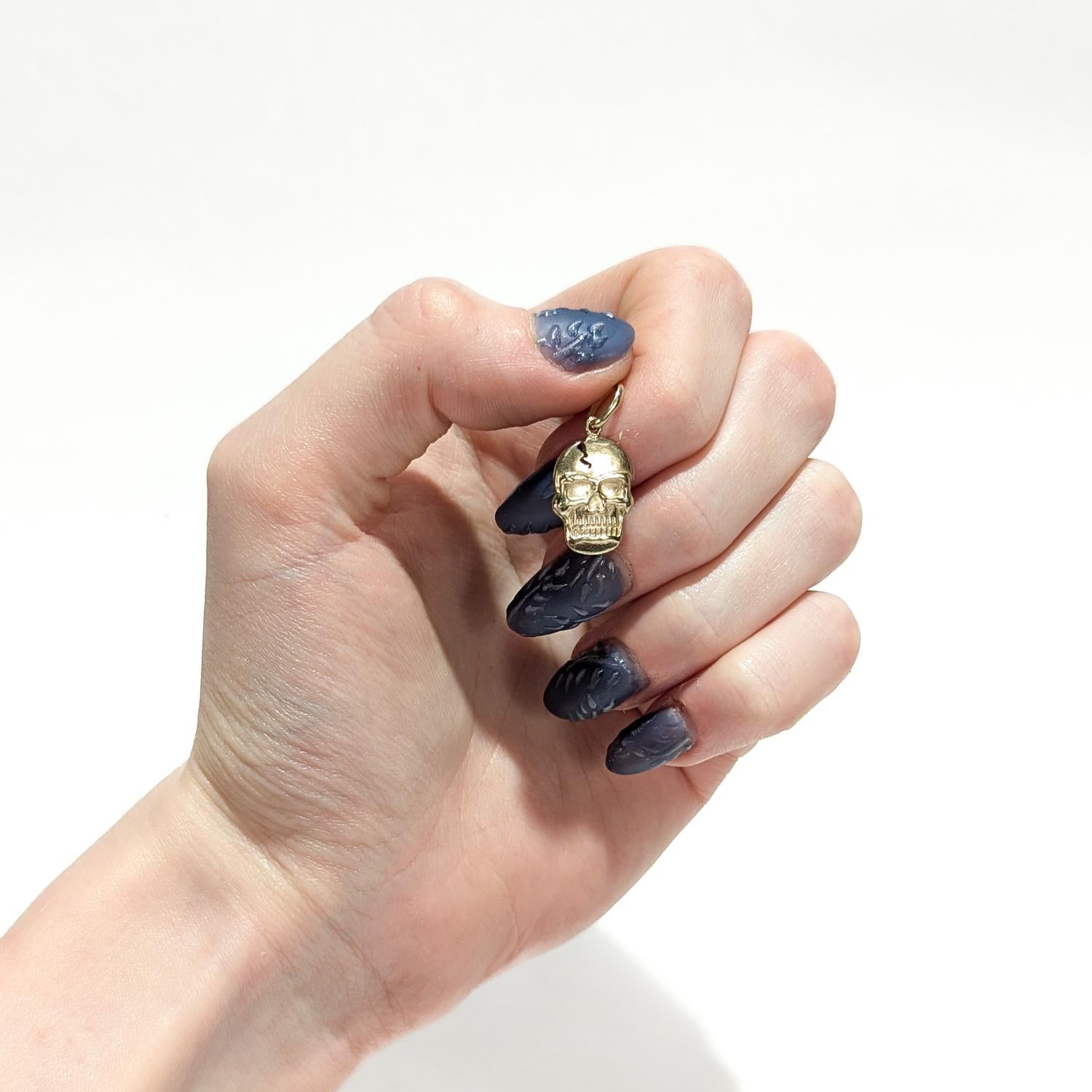 A fine vintage figural gold charm.

In 14 karat yellow gold.

In the form of a cracked skull.

With an integral bail and jump ring to the top.

Simply a wonderful charm!

Date:
20th Century

Overall Condition:
It is in overall good, as-pictured,